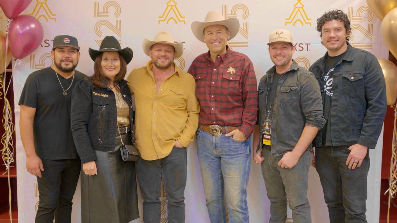 President Kelly Damphousse and First Lady Damphousse pose for a photo with Josh Abbott Band members.