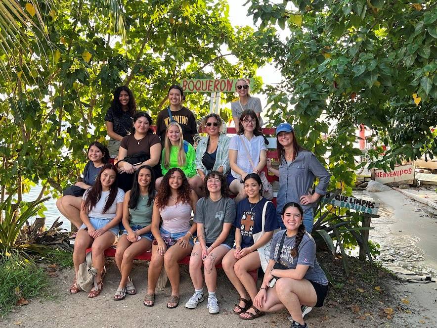 Graduate and Undergraduate students sitting at a roadside in Puerto Rico