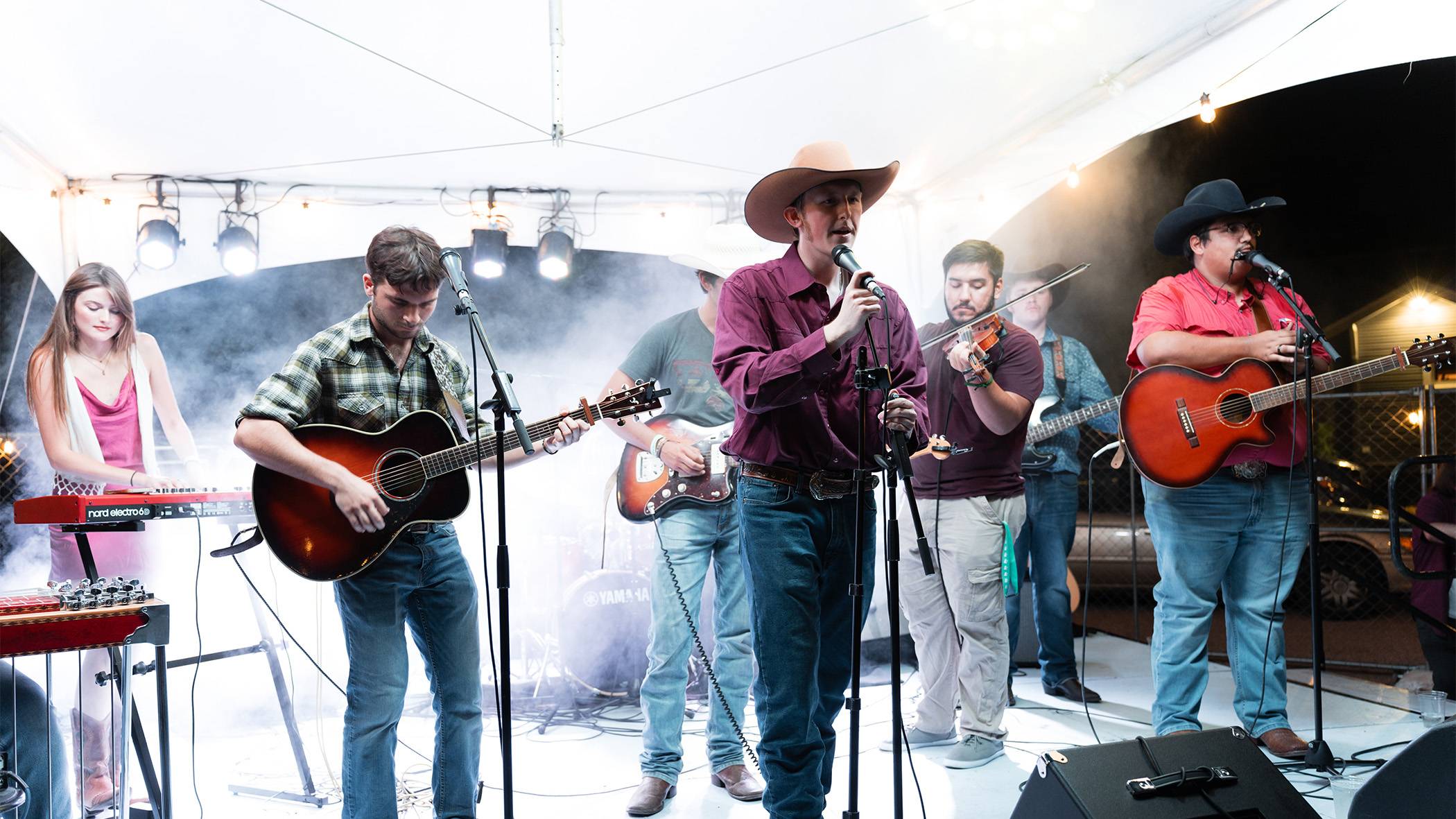 The band Bobcat Country performs on a stage