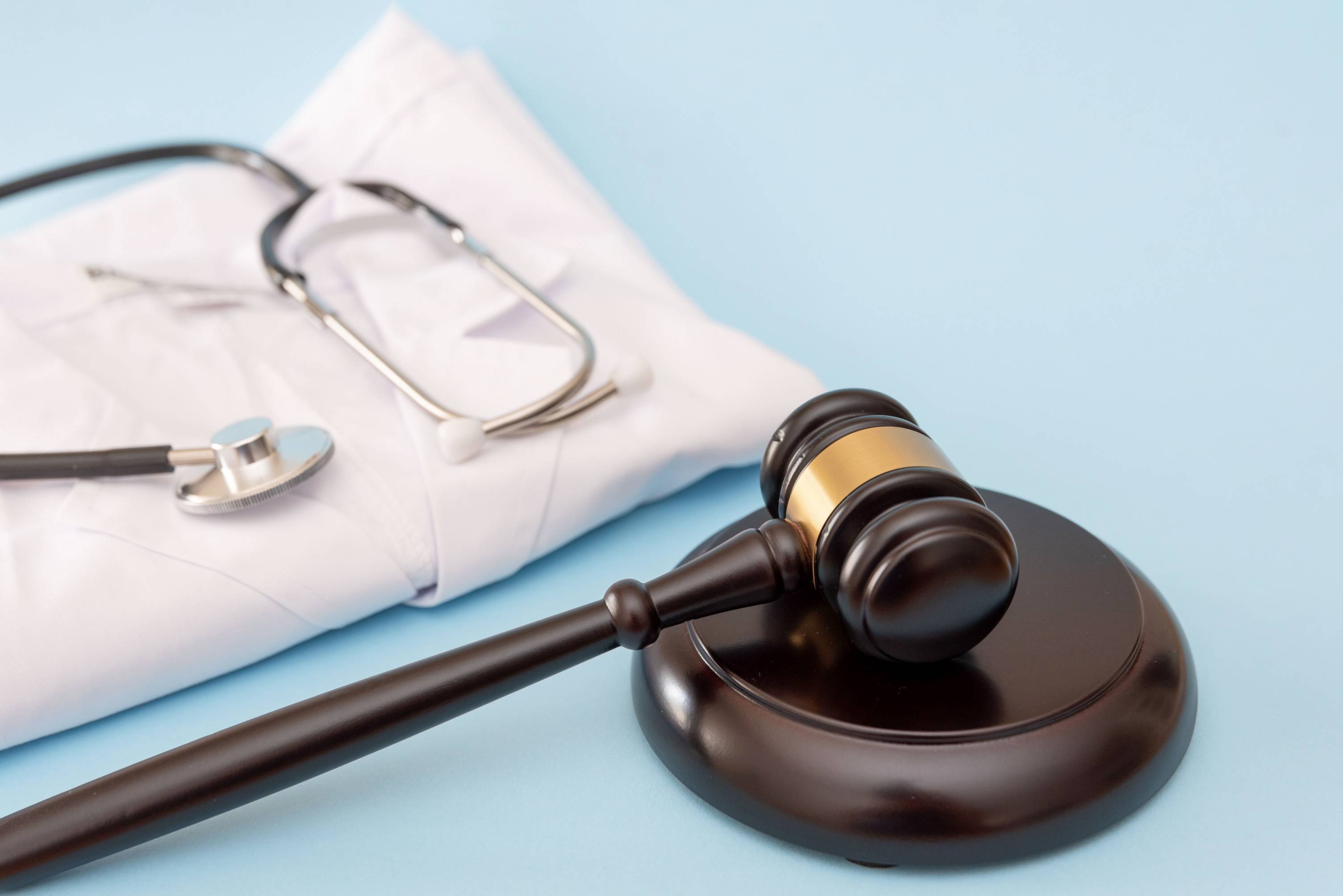 Stethoscope and gavel on desk.