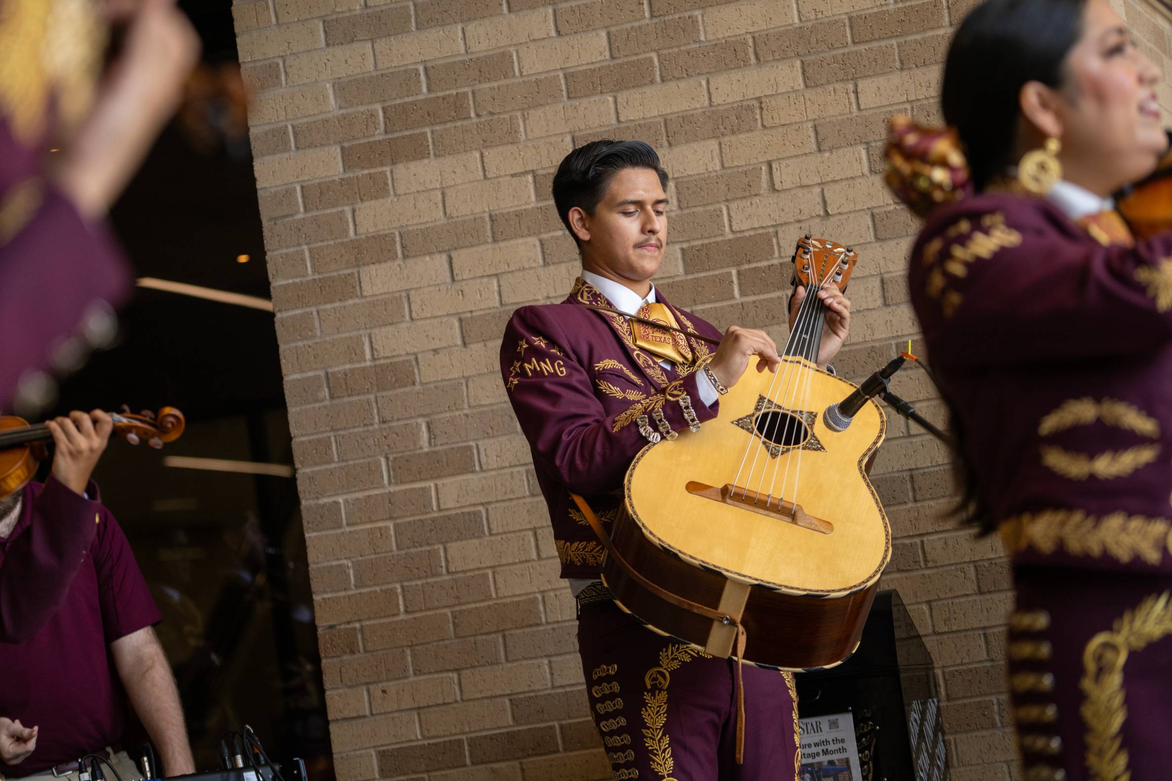 man playing a traditional mariachi guitar