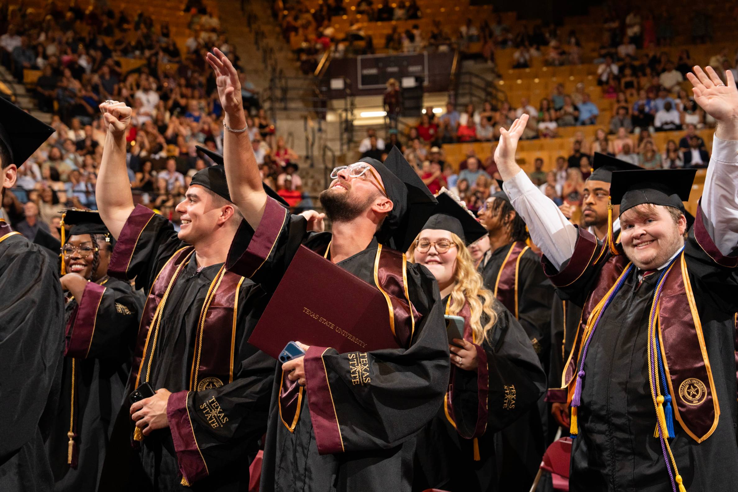 Students cheering at graduatoin