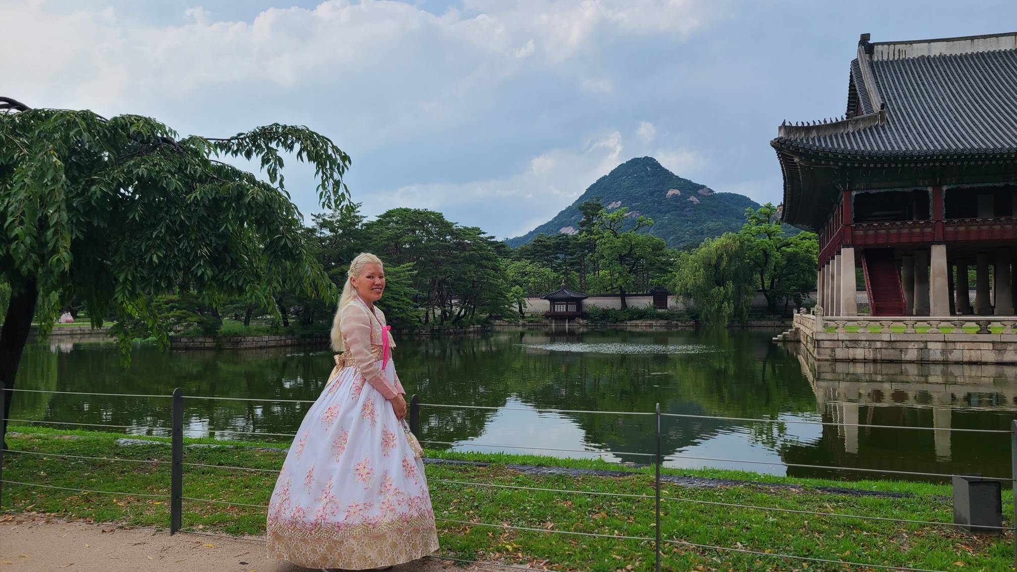 a student standing next to a lake in korea