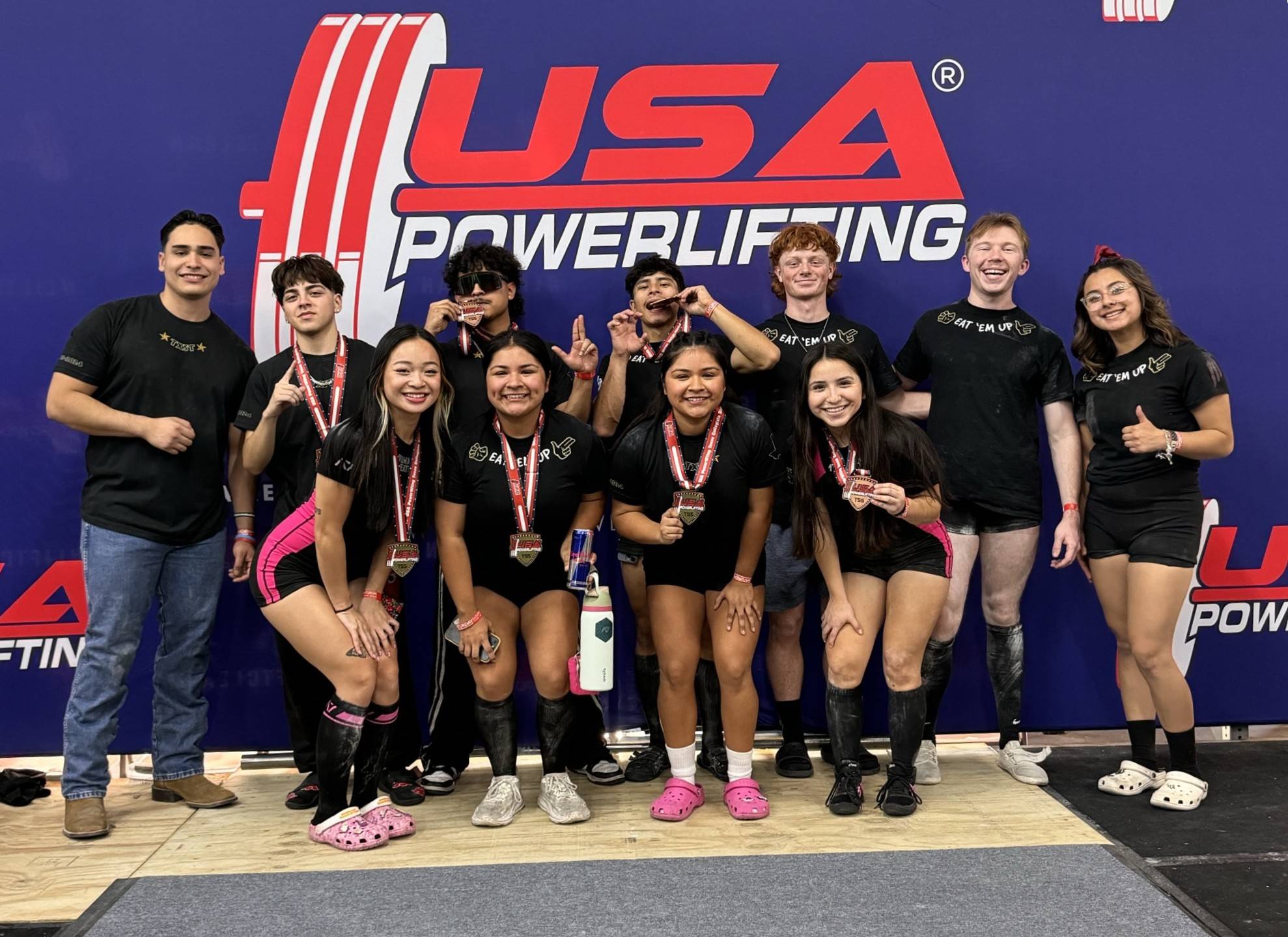 Powerlifting Sport Club posing after placing 1st in the women's division