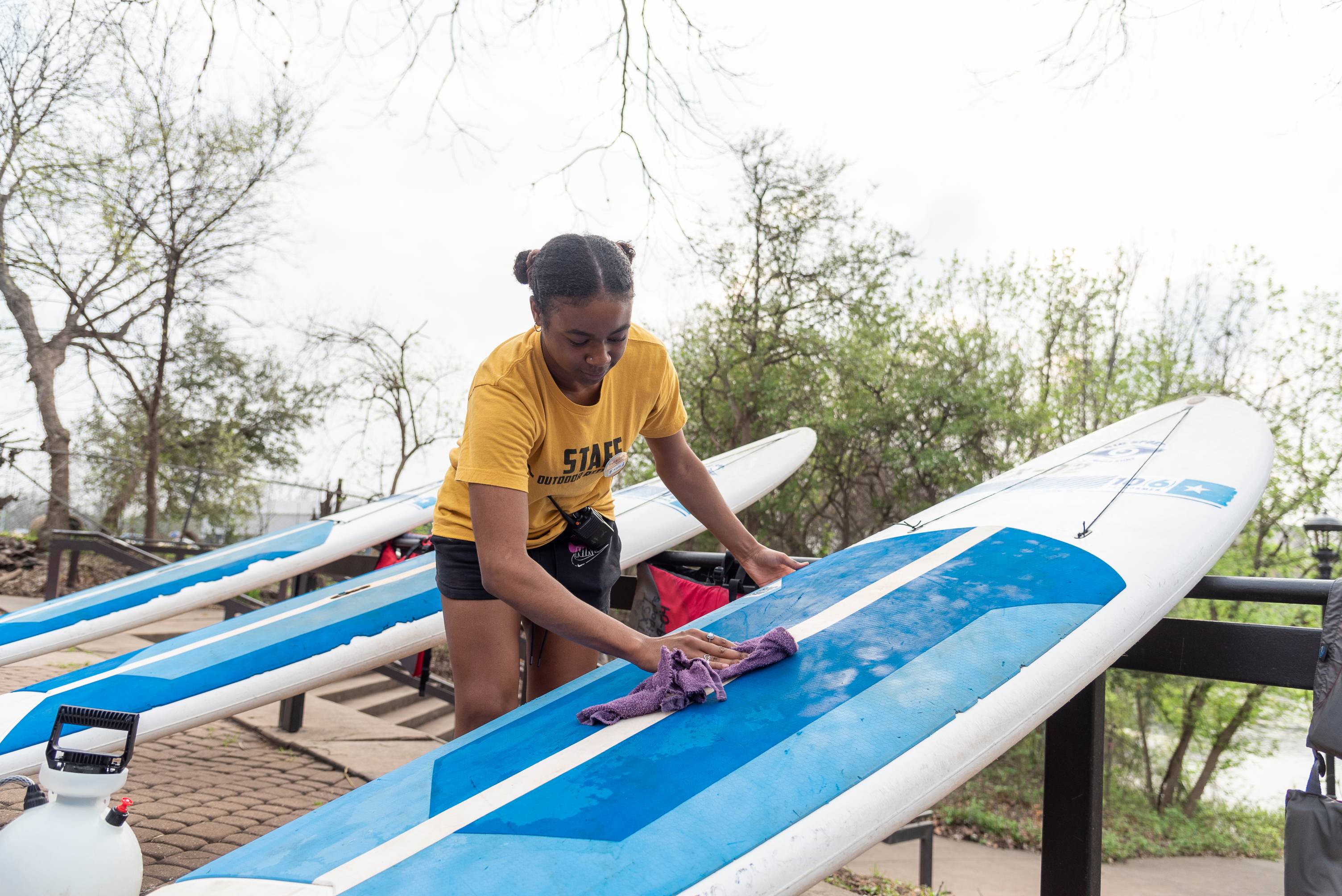 girl cleaning surfboard