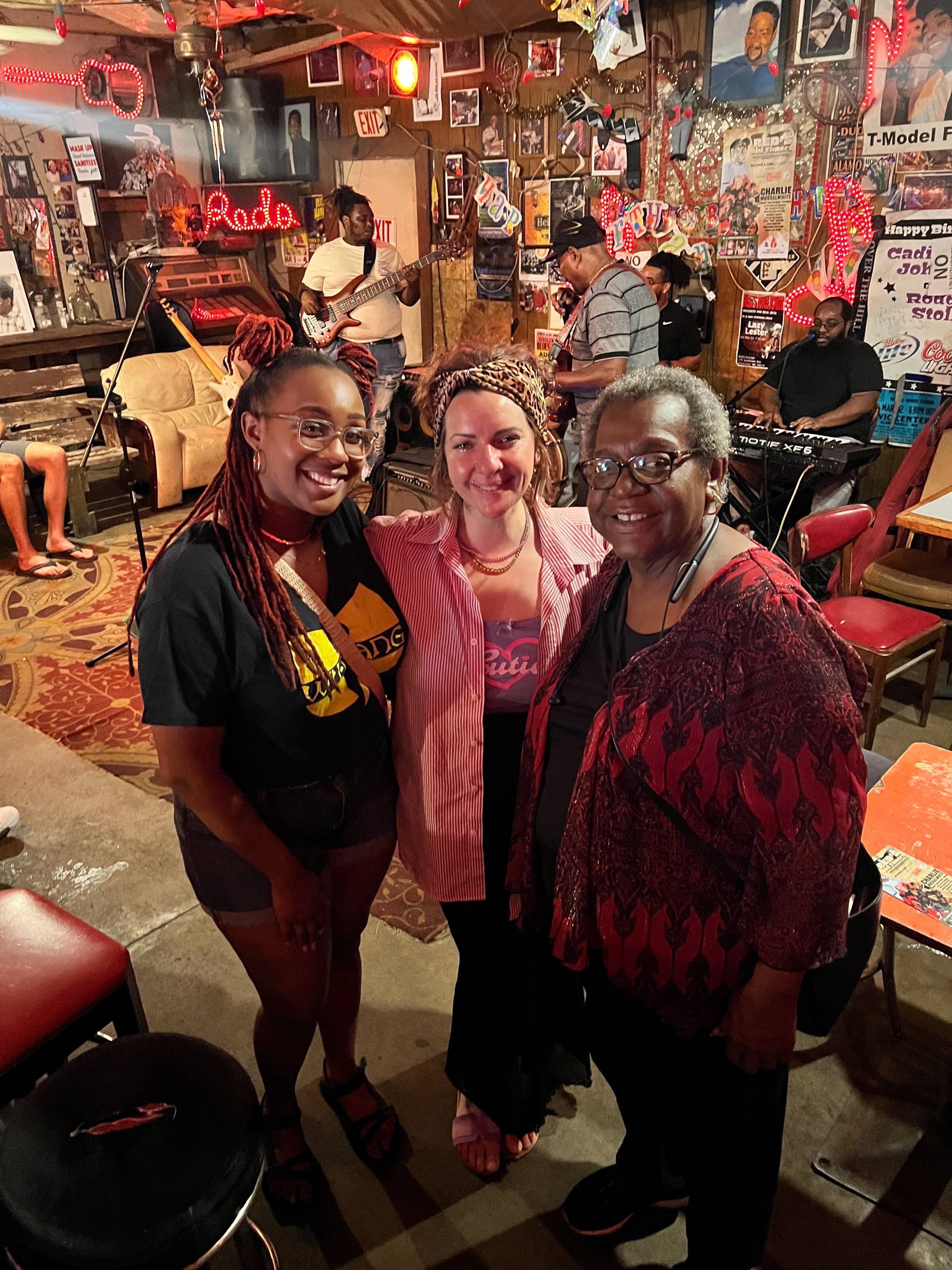 Mandy Truman (middle) poses for a photo with Edna Luckett (left), local blues/southern soul singer, and her mother Brenda Luckett (right), local civil rights activist, at Red's Lounge.