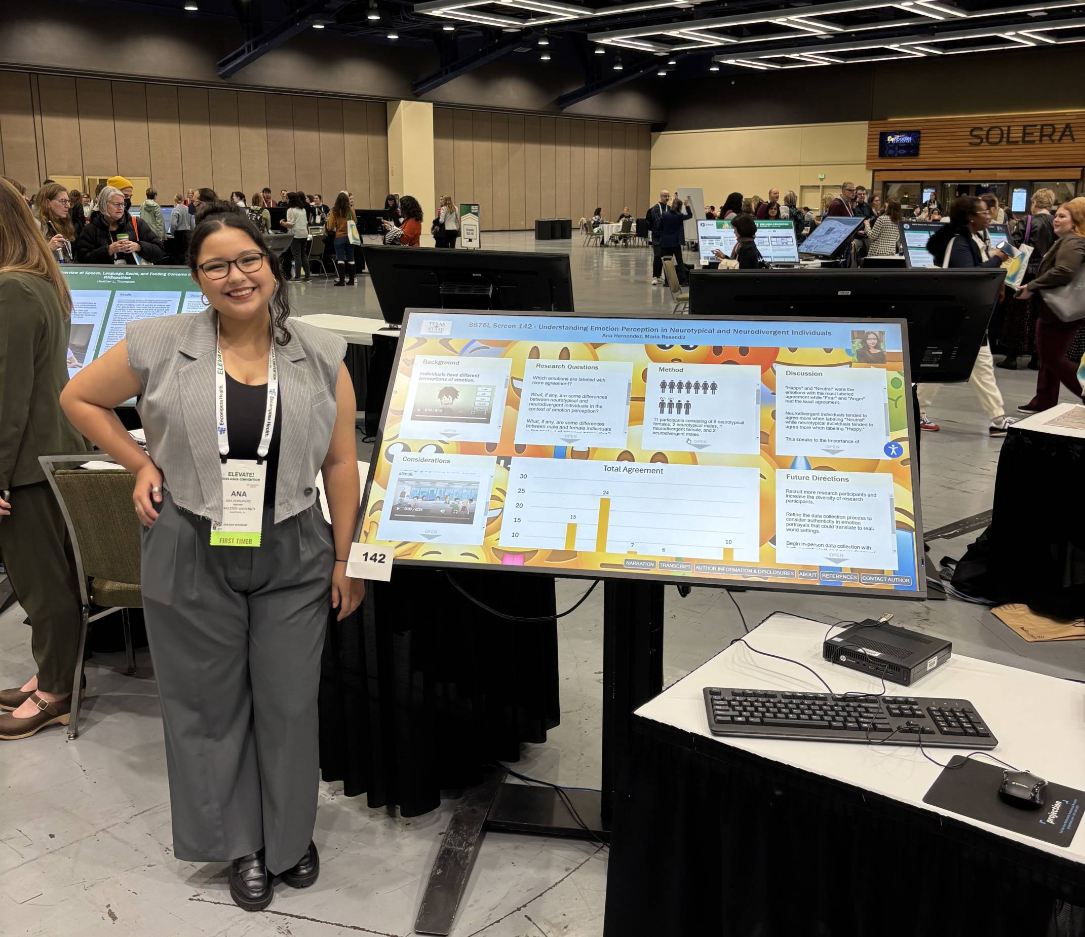 Ana Hernandez standing next to her poster.