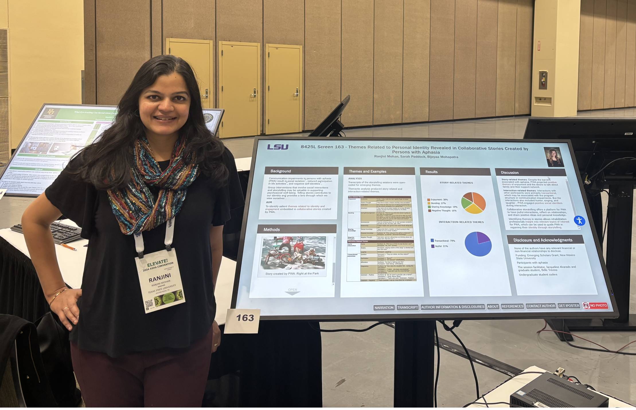 Dr. Mohan standing next to her poster in the ASHA Convention 2024