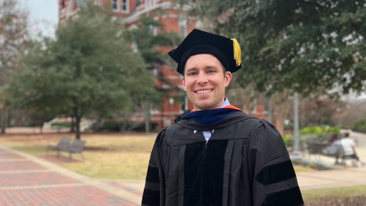 Jake Waddingham in doctoral graduation robes