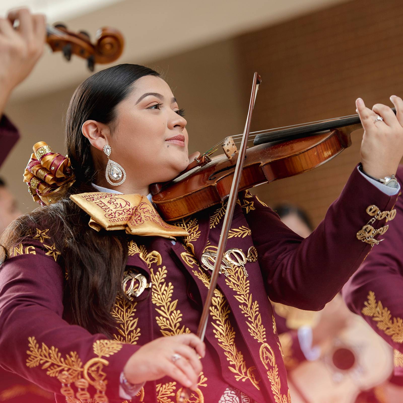 A violinist playing in a mariachi ensemble at the Texas State campus.