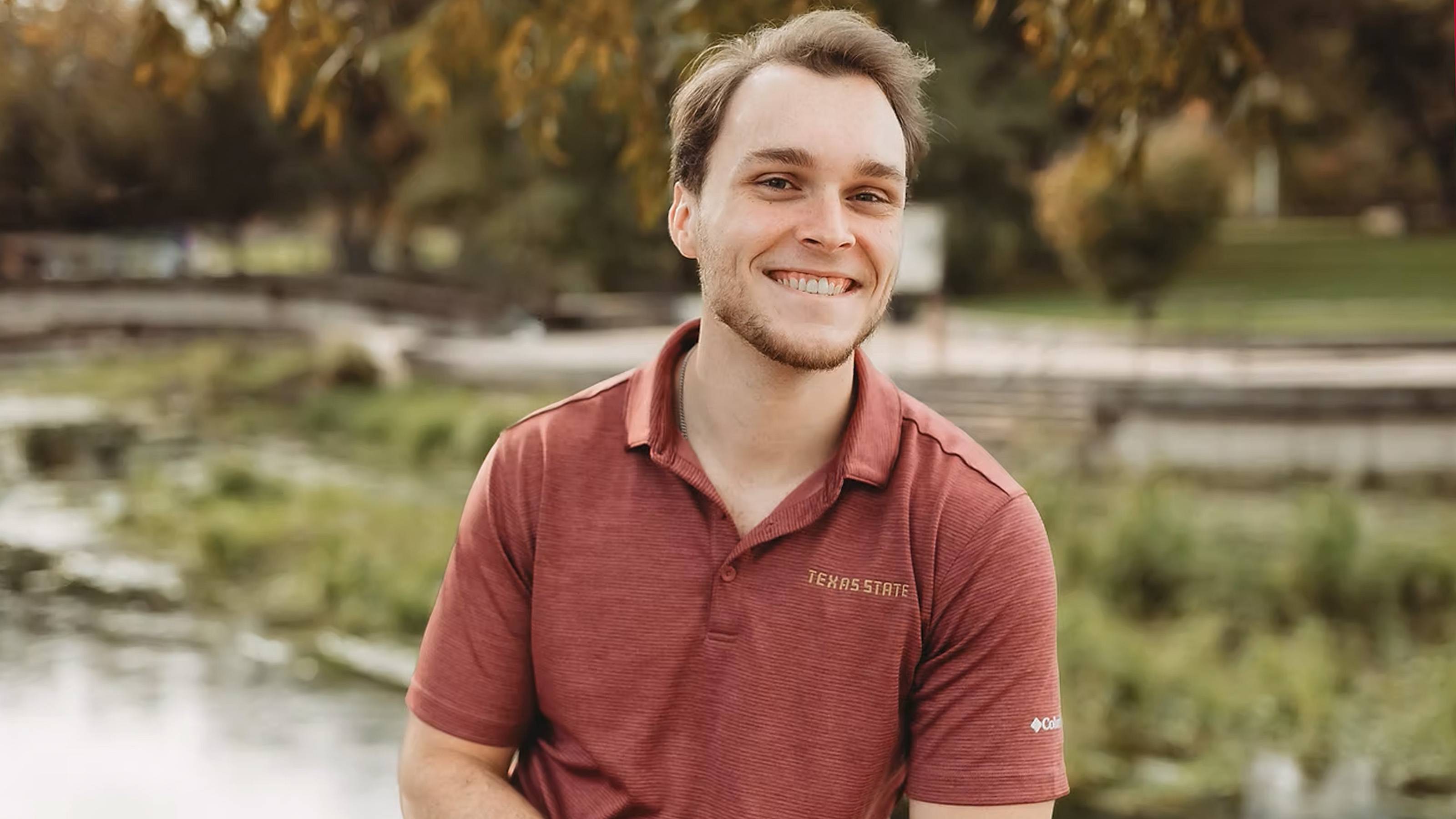 Mason Espedal posing beside San Marcos River