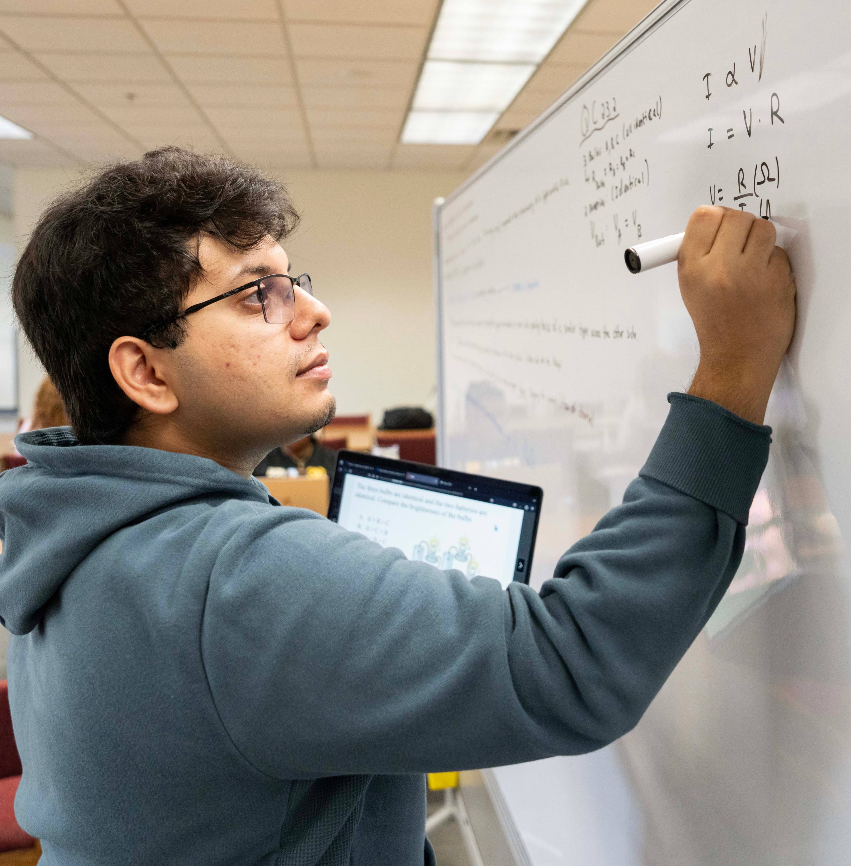 student working on library white board