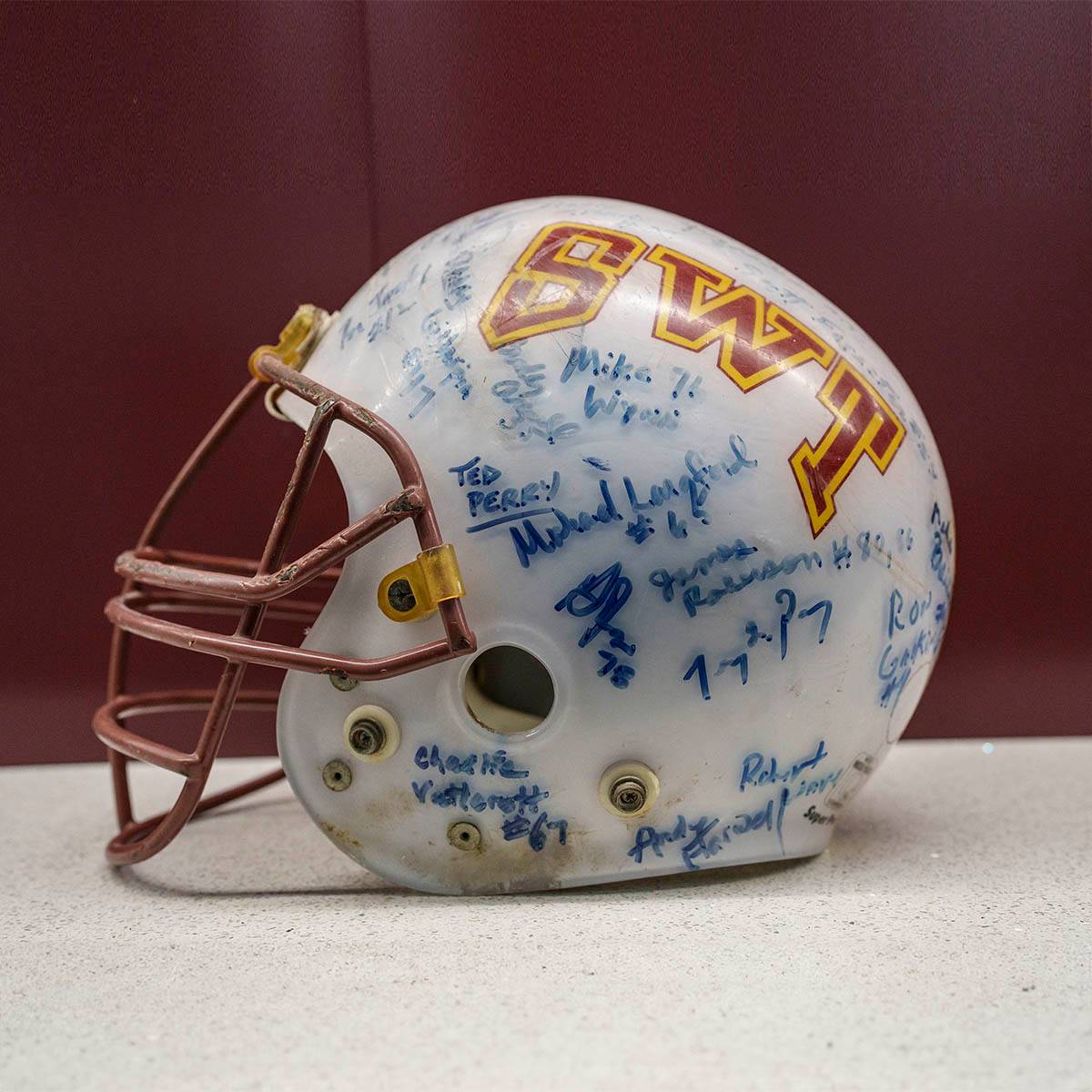 A miniature Southwest Texas State University football helmet from 1982, signed by all the players.