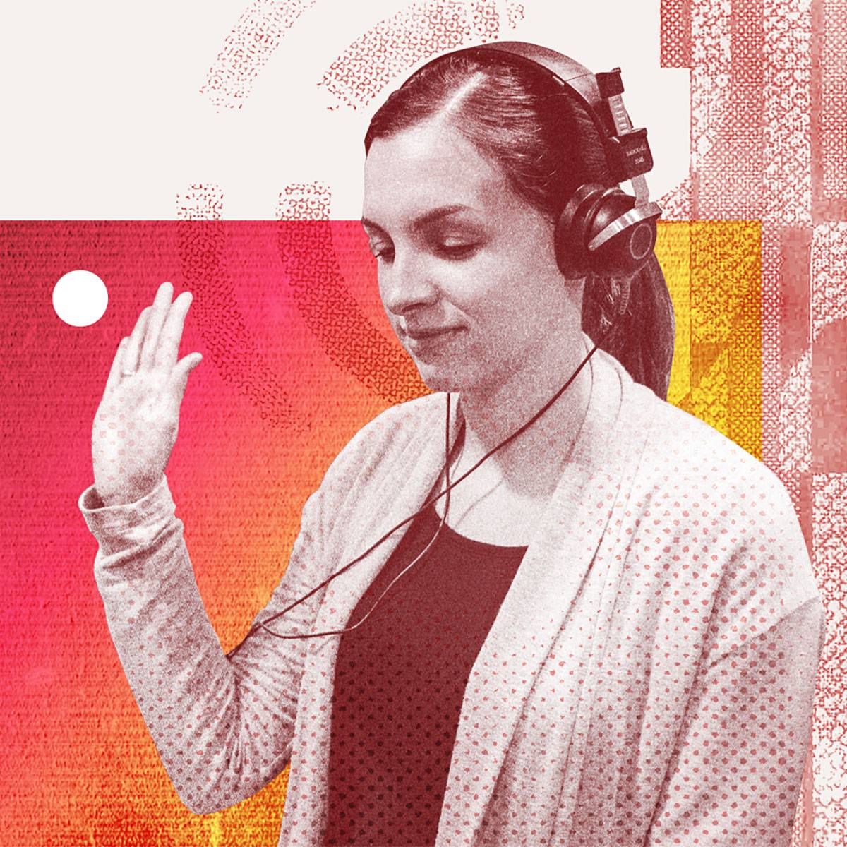 A young woman holds her palm up during a hearing test, indicating she can hear the tone.