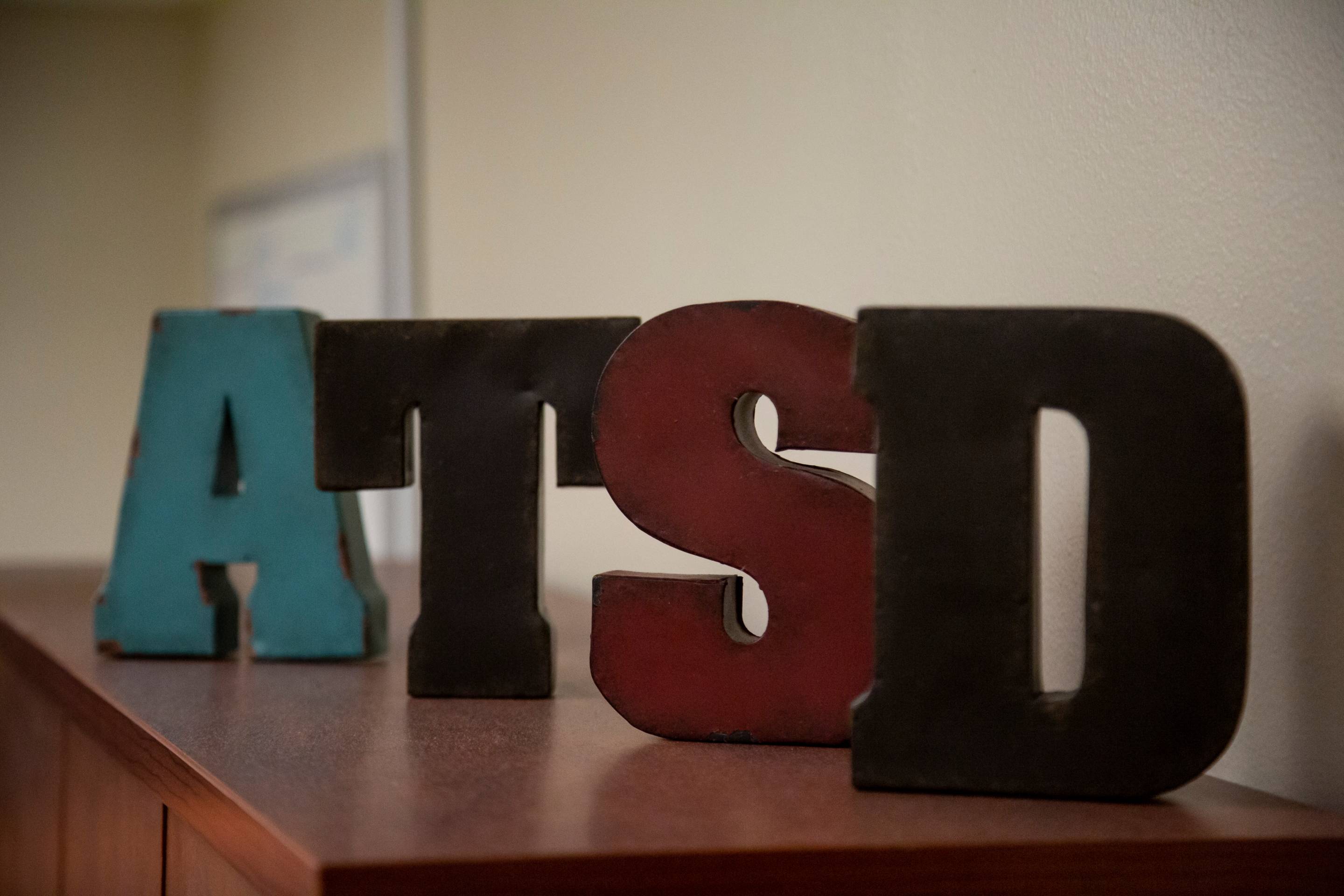 Block letters on a countertop spelling "A-T-S-D"