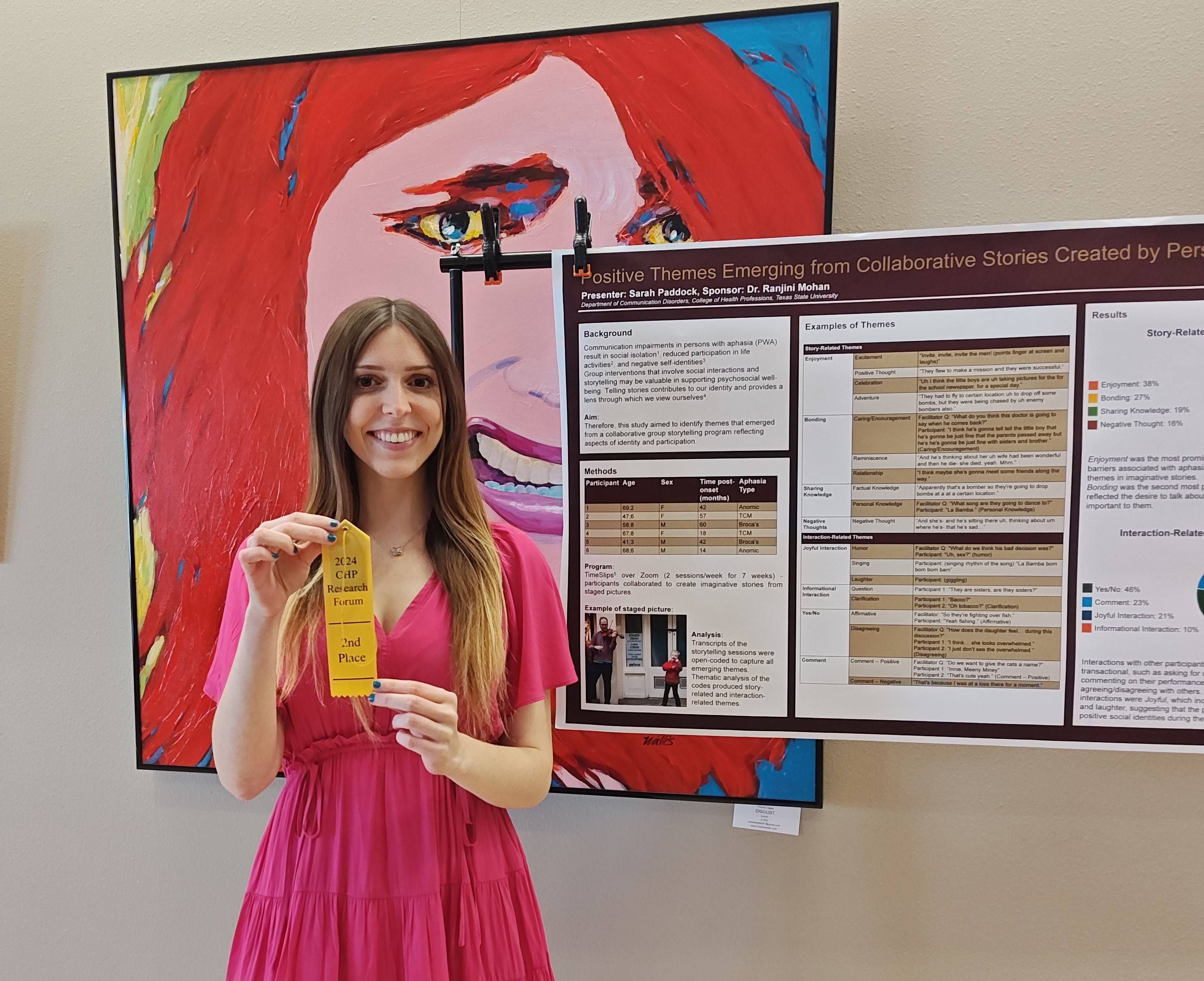 Sara standing next to her poster.