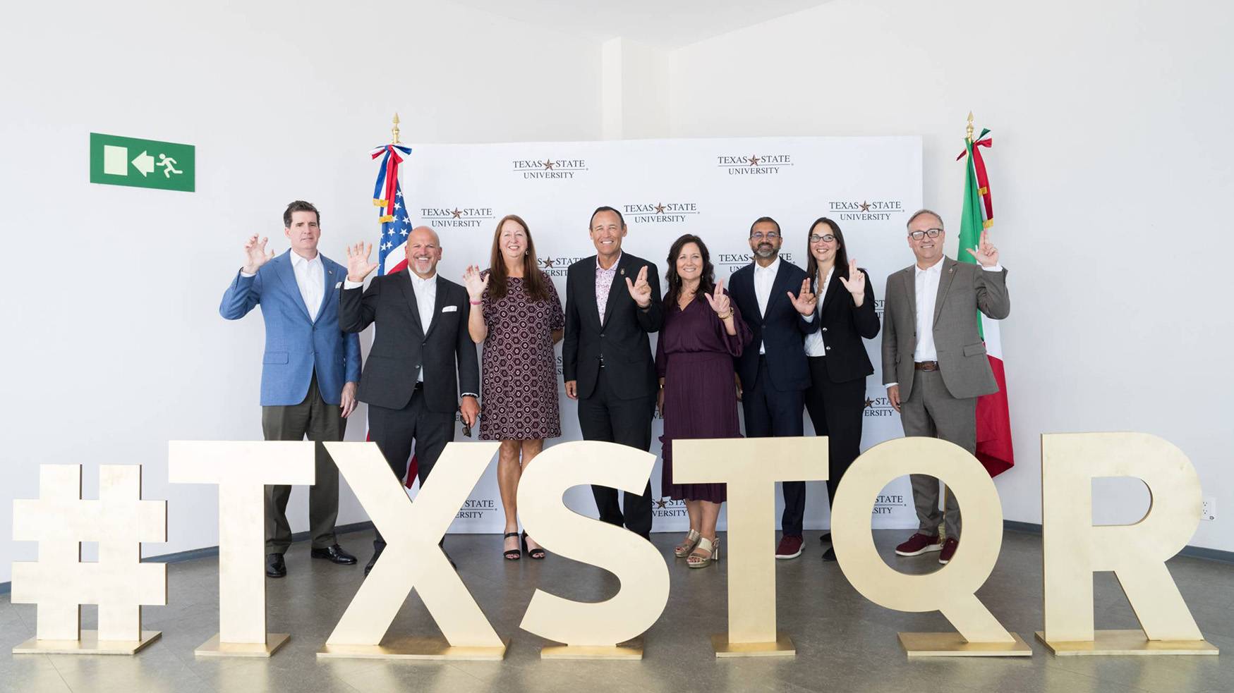 President Kelly Damphousse poses for a photo with TXST staff members at the new campus in Mexico.