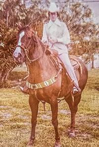 Vintage photo from 1970's of a Ruvalcaba in cowboy hat riding on a brown horse.