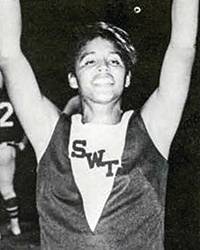 Yearbook snapshot of Faulkner at a game in her cheer uniform, SWT is embroidered across the chest.