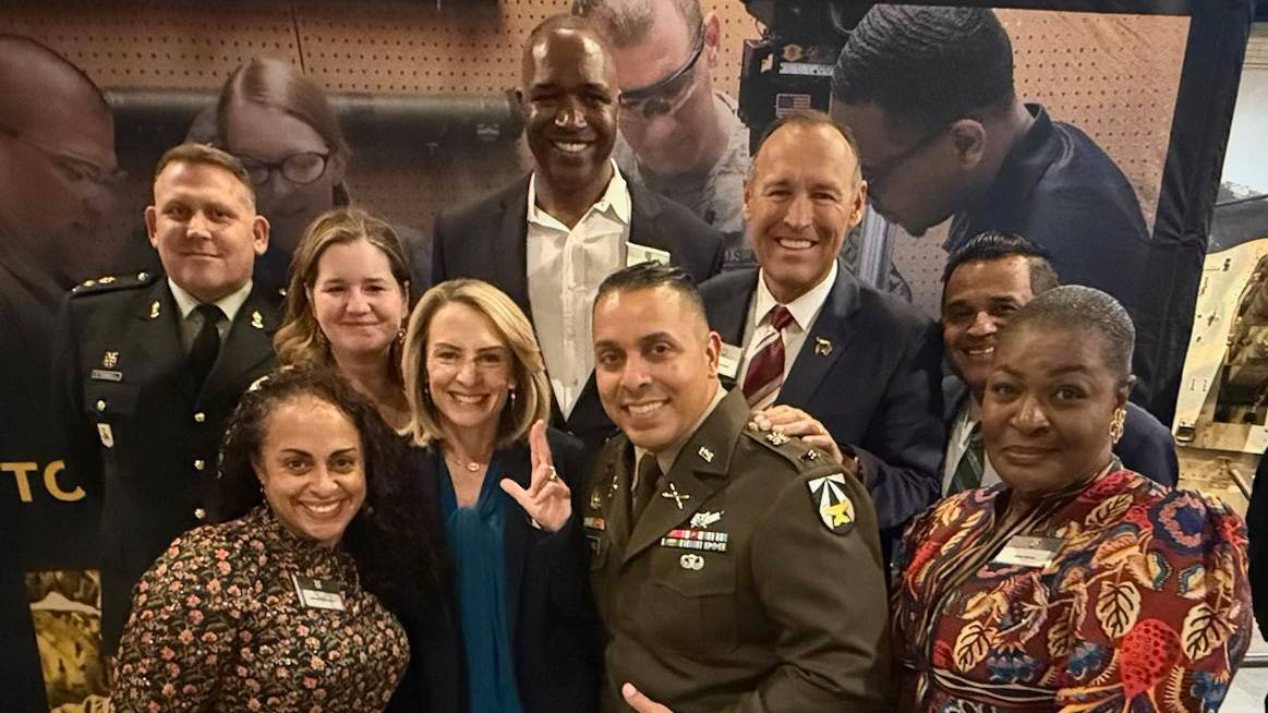 President Kelly Damphousse poses for a photo with TXST leadership and members from Camp Mabry.