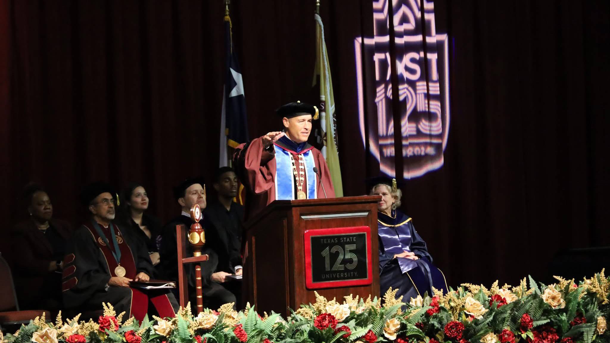 President Damphousse speaks on stage during a Fall 2024 Commencement ceremony.