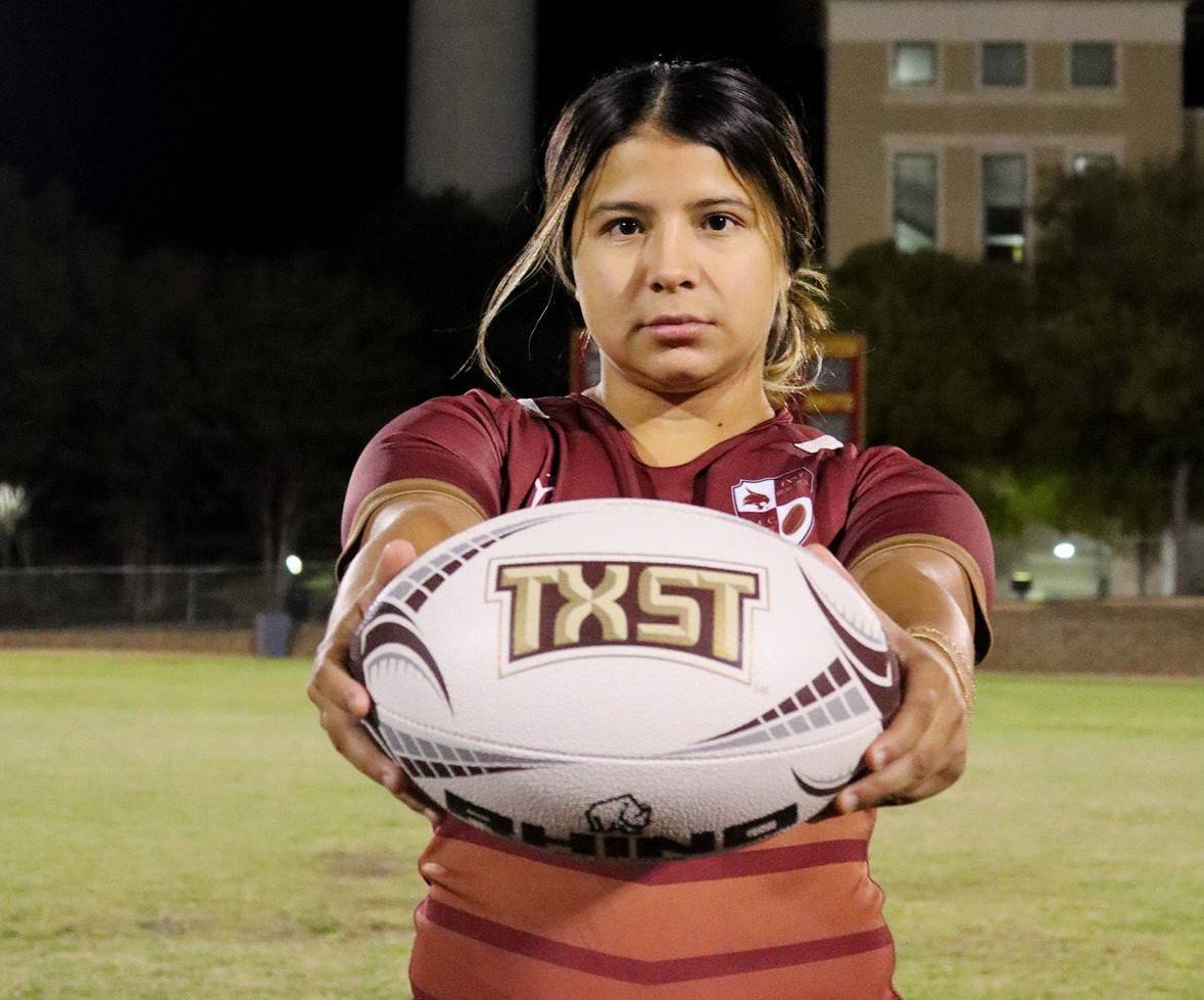 Women's Rugby player holding ball