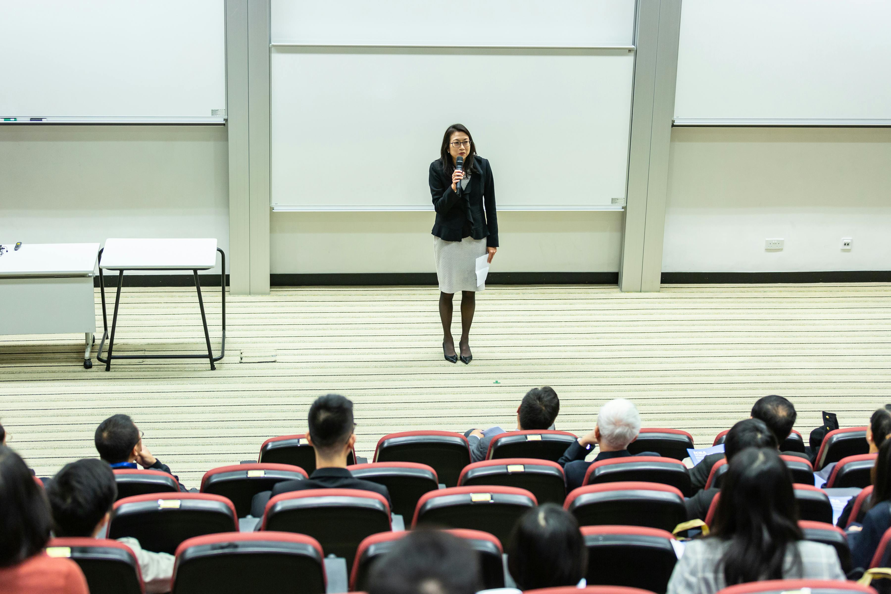 A female student looking at multiple computer screen with medical coding content