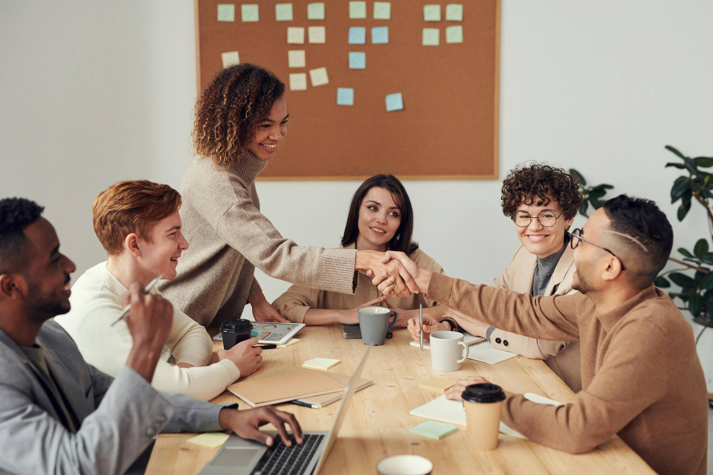 Many uniting at the table smiling