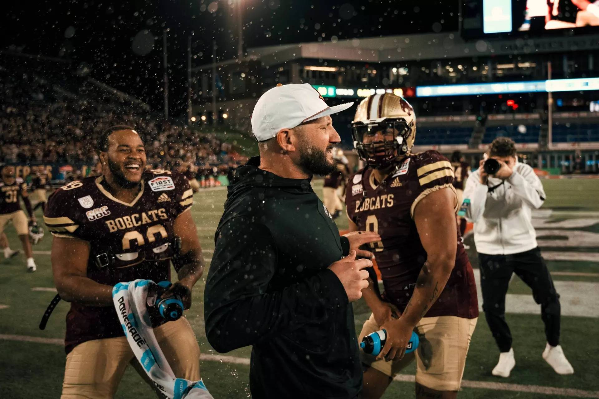 football players celebrate on a field 