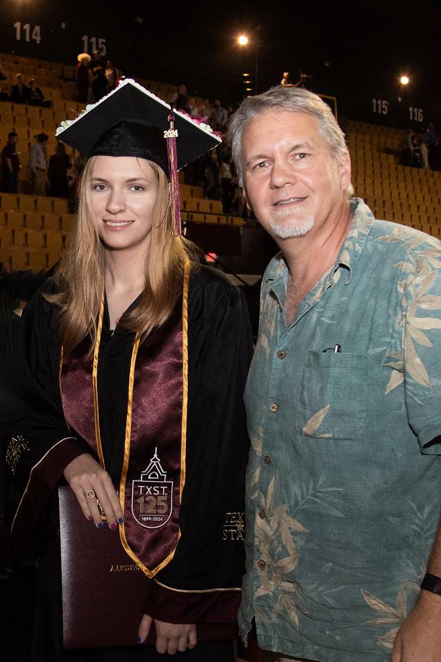 a father and daughter posing for a photo