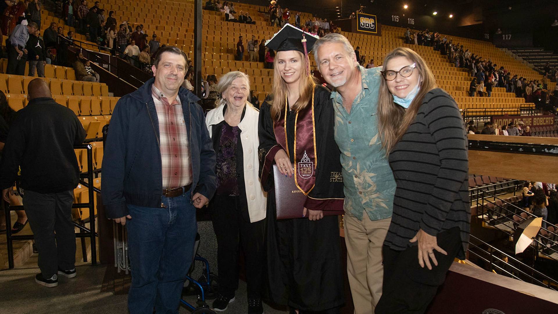 a family poses for a group photo at a commencement ceremony