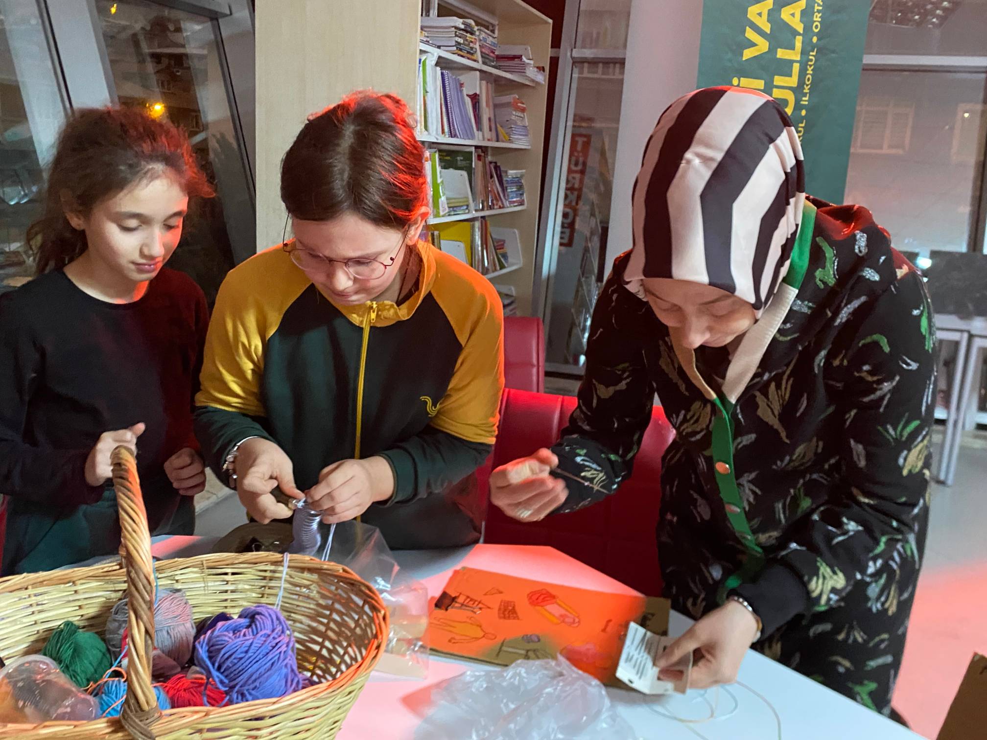 Yedi Vadi [Seven Valley Schools] 5th grader teaching her mother and sister how to bind a cartonera book.