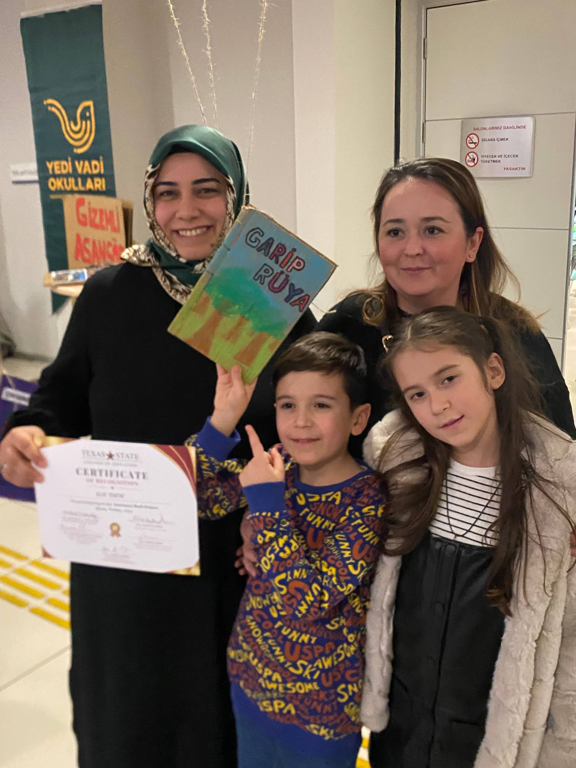 Elif Özkan, third grade teacher, with student and family at Seven Valley Schools Cartonera Book Exposition