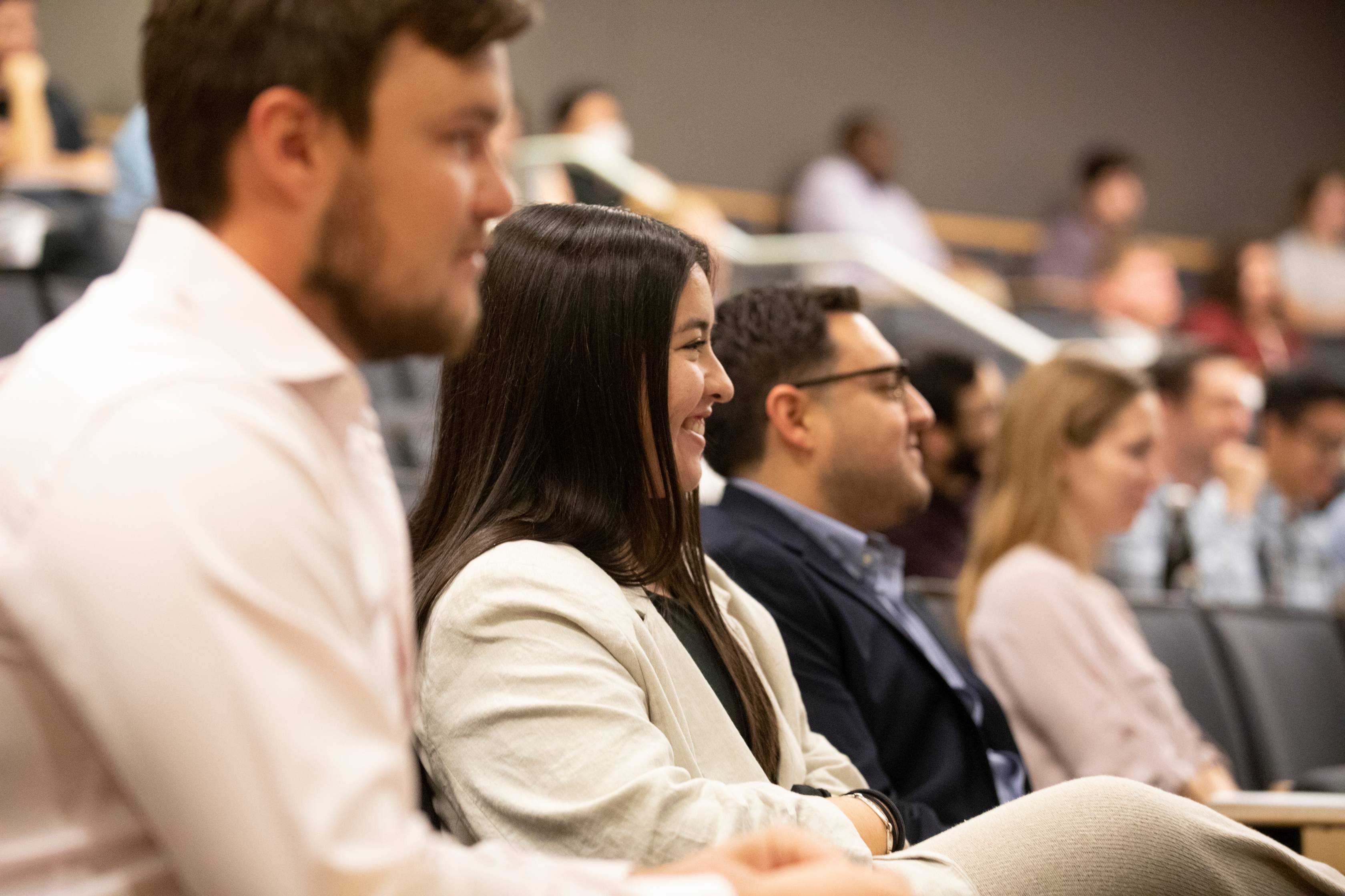 Innovation Series: lecture hall of people listening to pitch ideas 