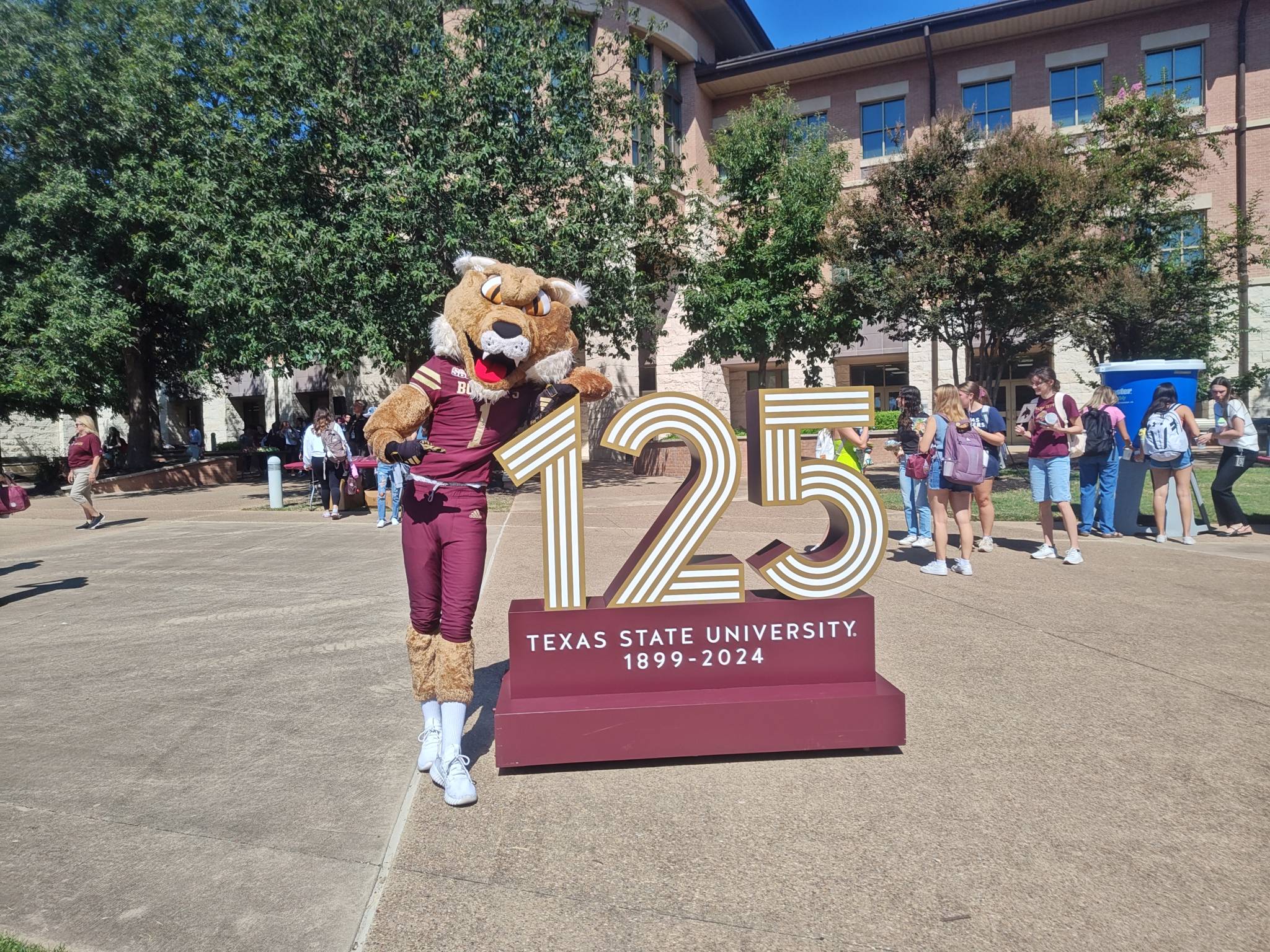 Boko standing next to a 125th anniversary logo