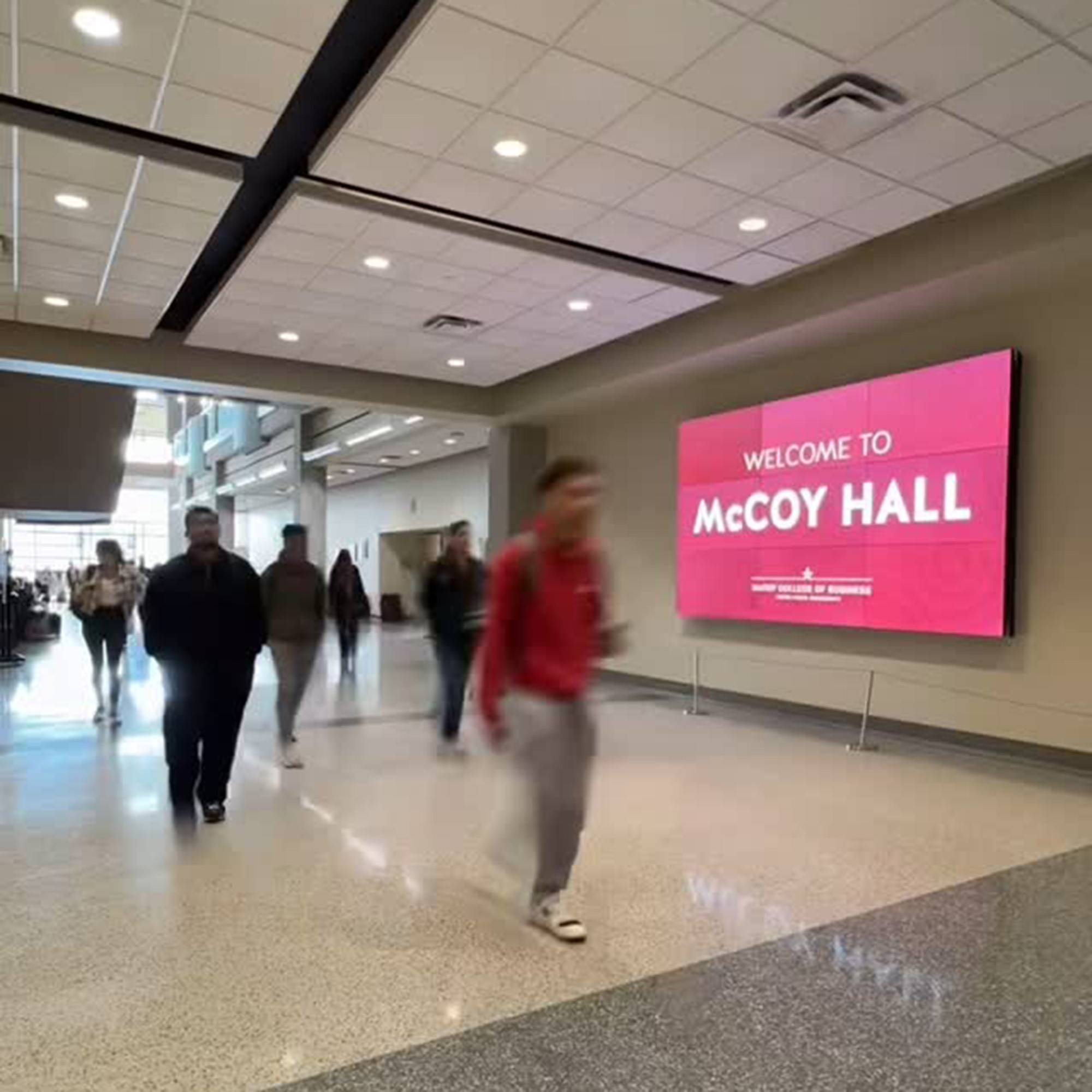 Still frame of timelapse video of students walking in McCoy Hall lobby