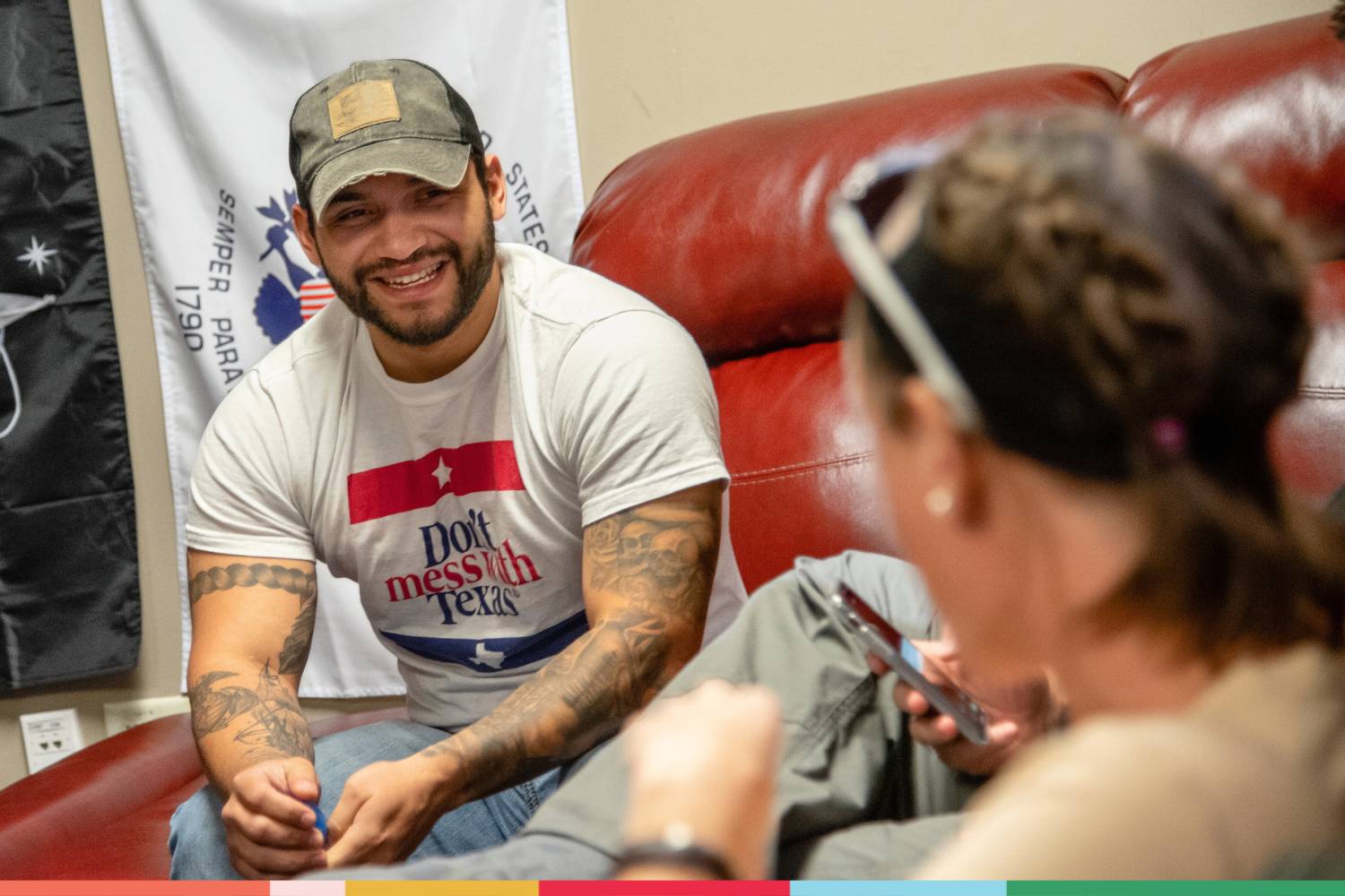 A student smiling and laughing while having a conversation