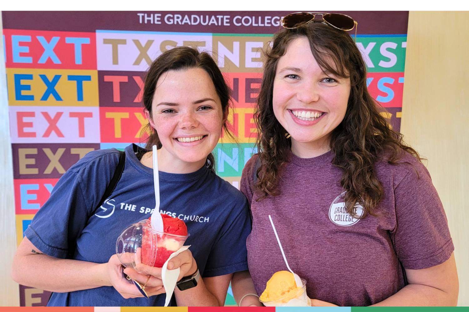 Two students smiling while holding up their gelato