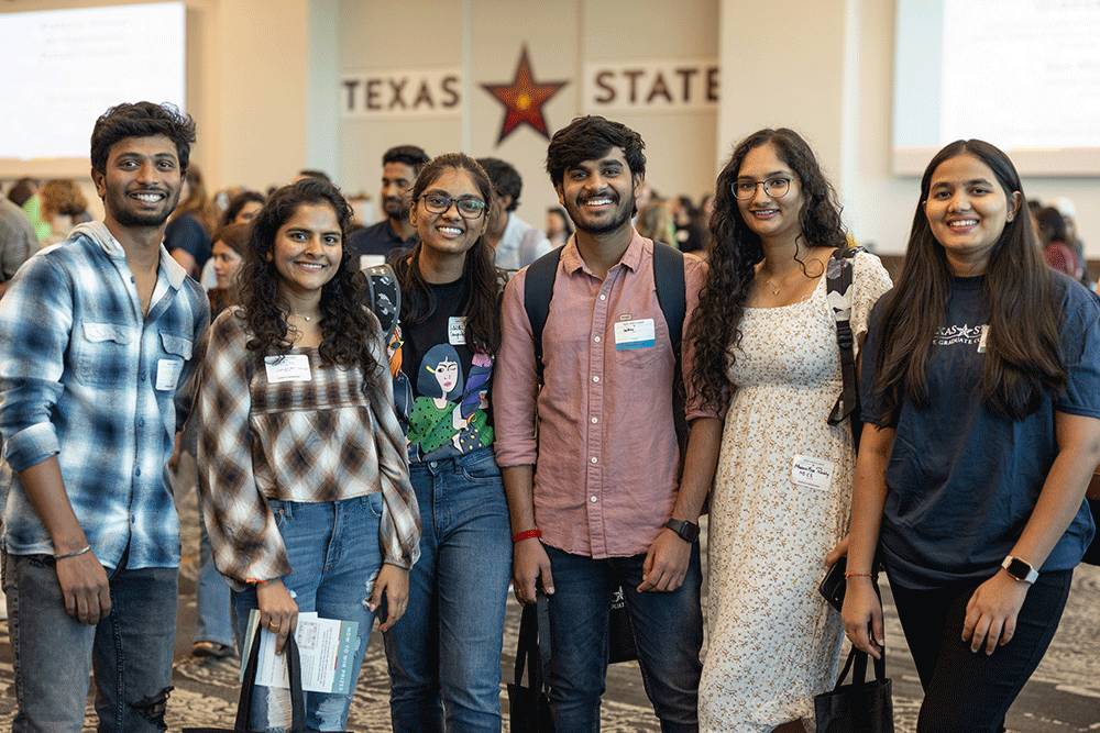 a group of prospective students happily smiling for a photo 