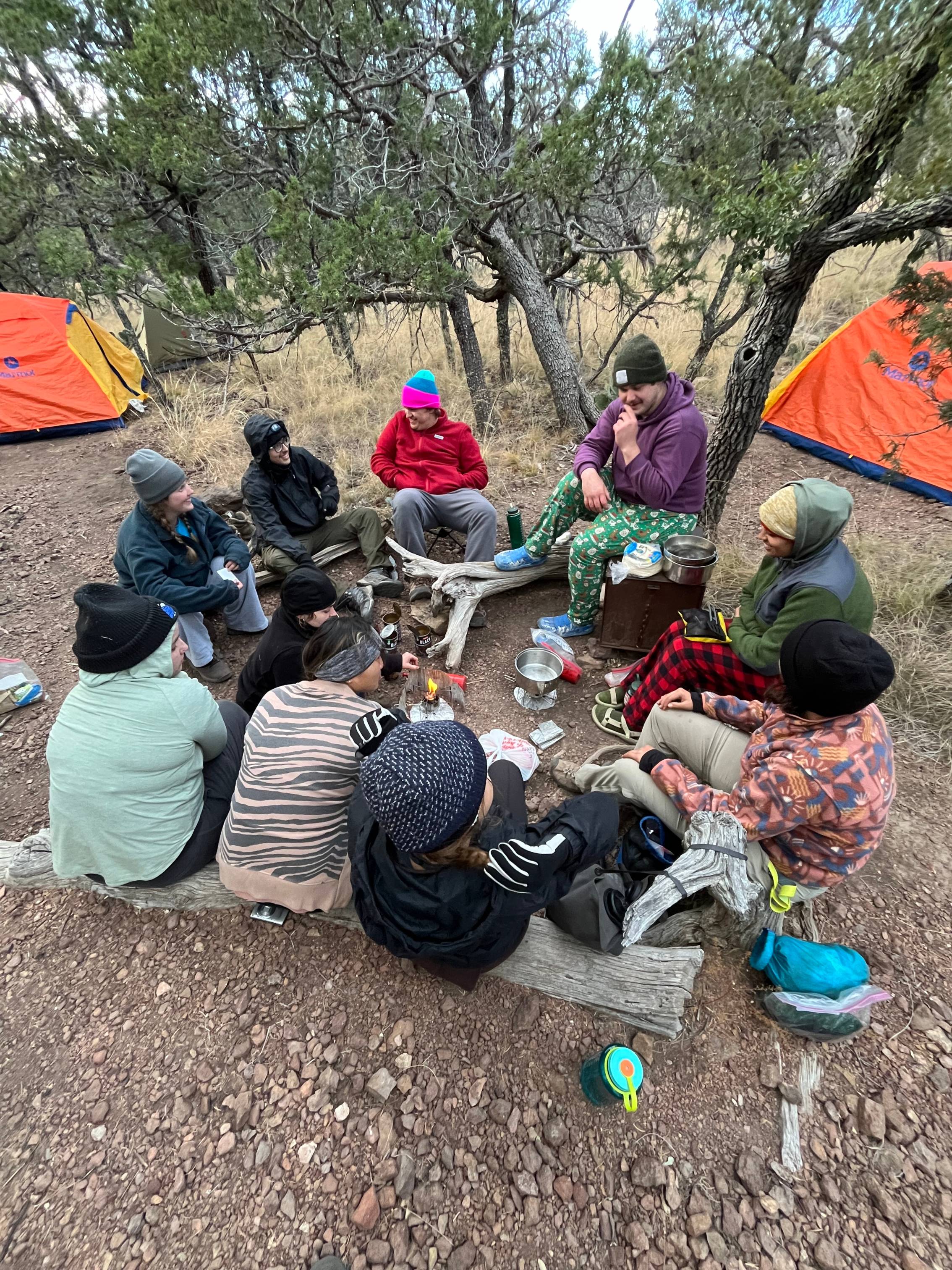Students sitting together at a campsite