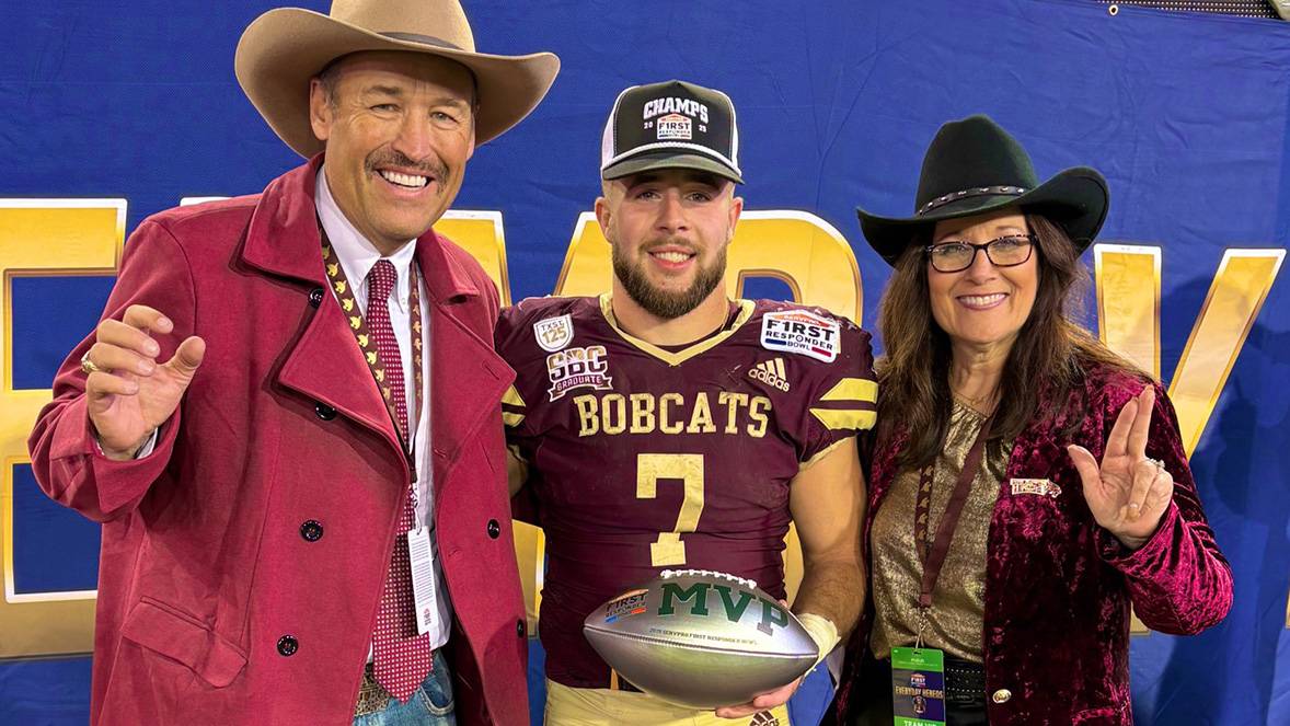 President Kelly Damphousse (left) poses for a photo with the bowl game MVP Lincoln Pare and First Lady Beth Damphousse.