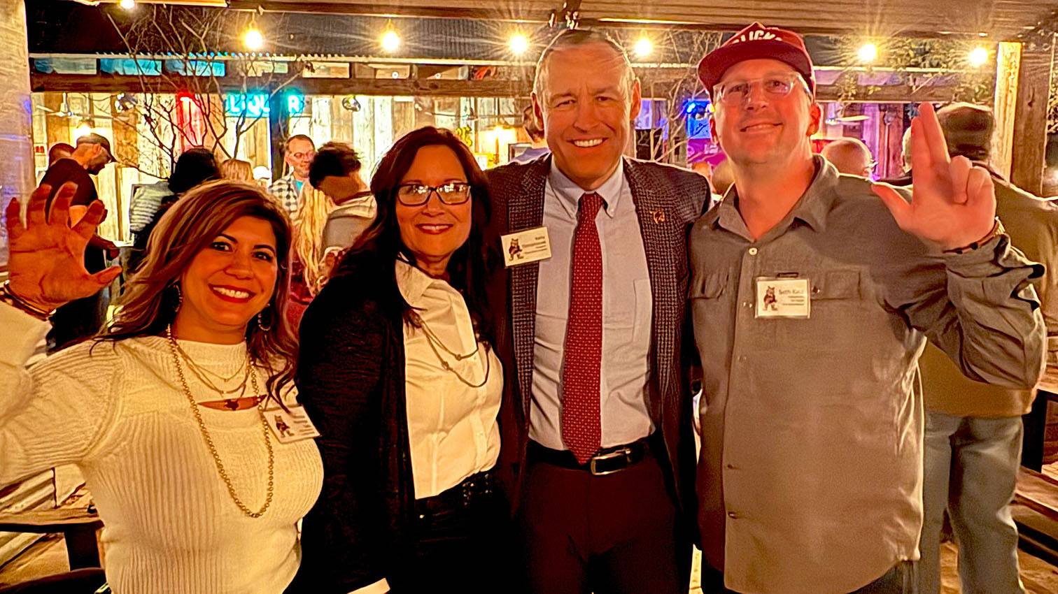 First Lady Beth Damphousse (middle left) and President Kelly Damphousse (middle right) poses for a photo at Zelicks with two attendees.