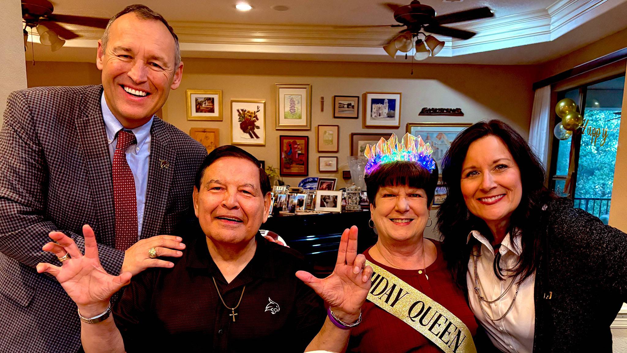 President Kelly Damphousse (left) poses for a photo with John Navarette, Chloe Navarette, and First Lady Beth Damphousse.