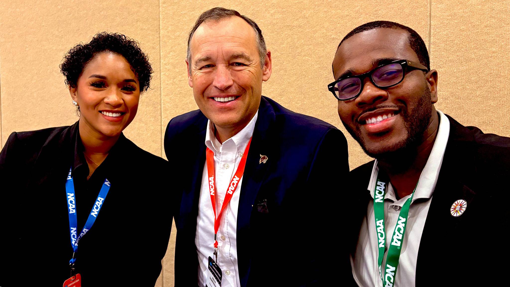 President Kelly Damphousse (middle) poses for a photo with two university leadership representatives.