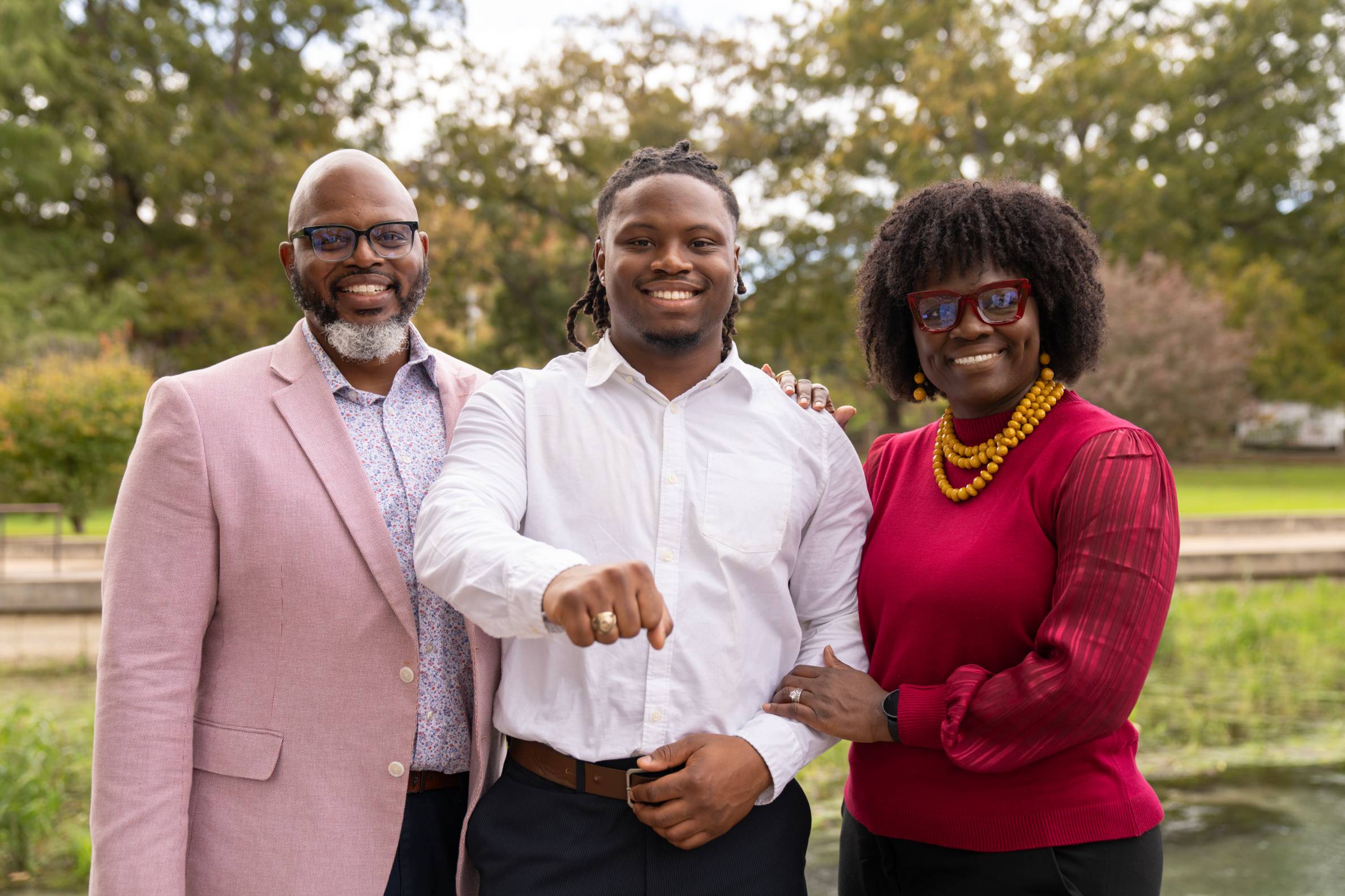 A student proudly poses with his family after receiving her TXST ring.