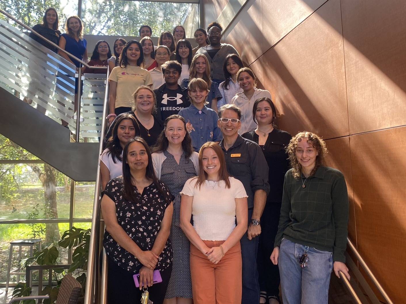 HDFS Faculty and REU Fellowships standing on a staircase