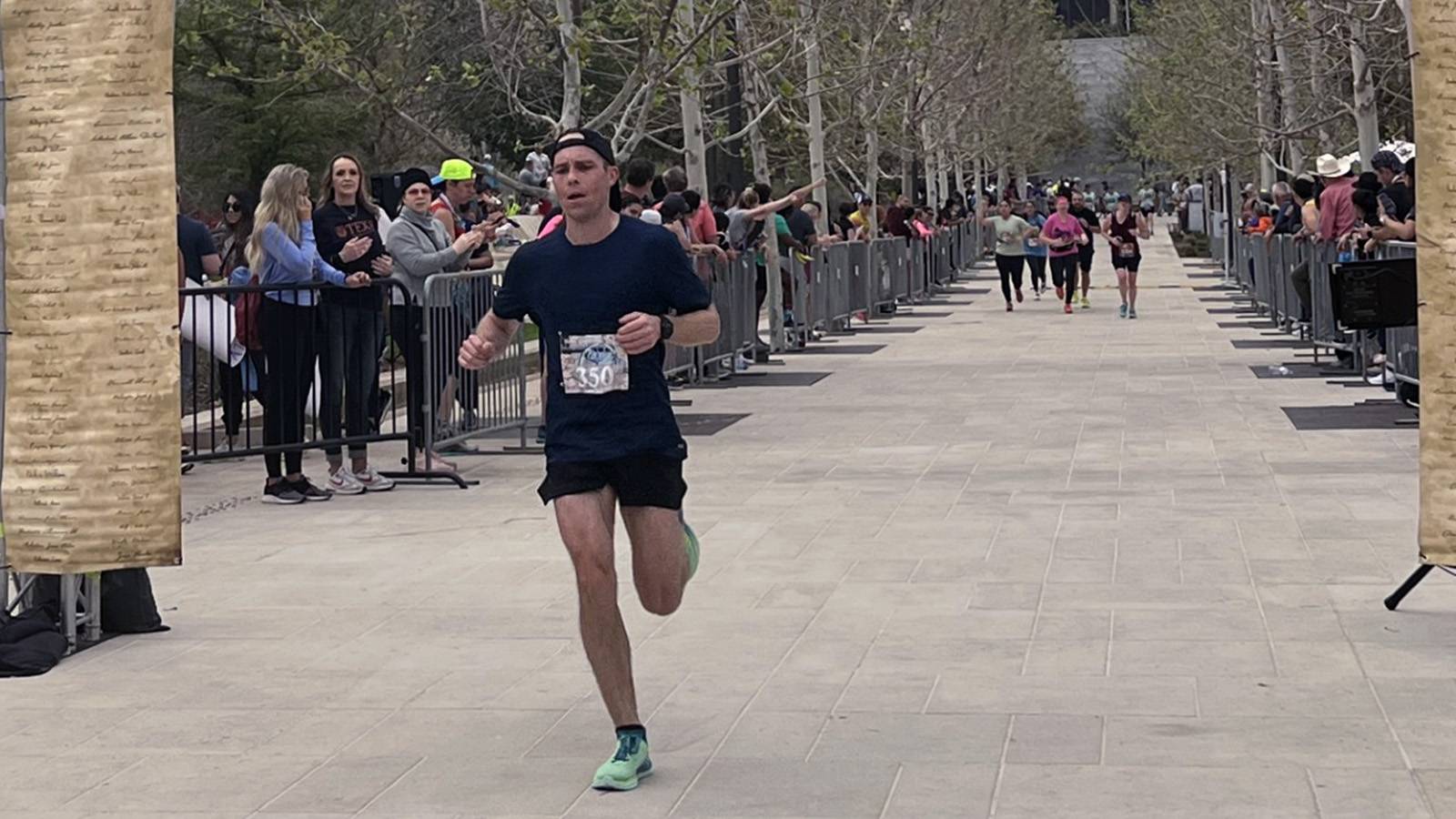 man running across finish line