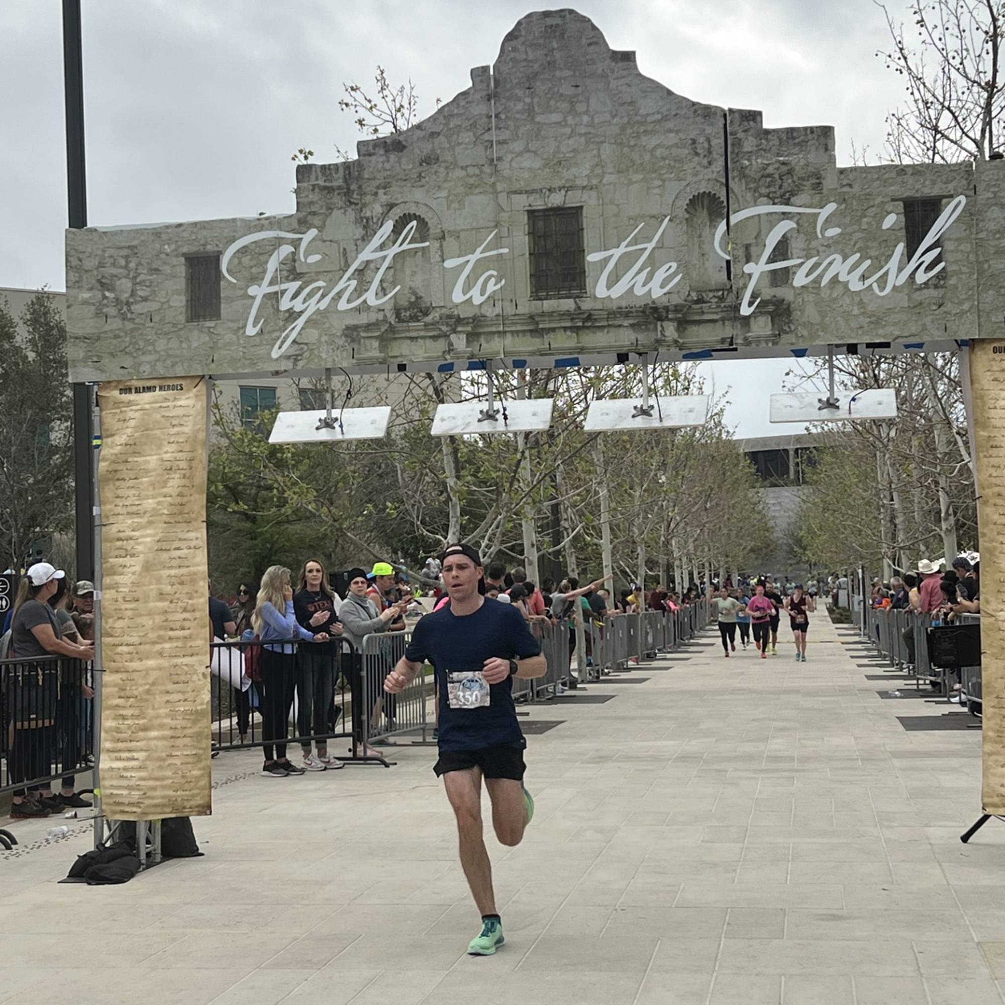 man running across finish line