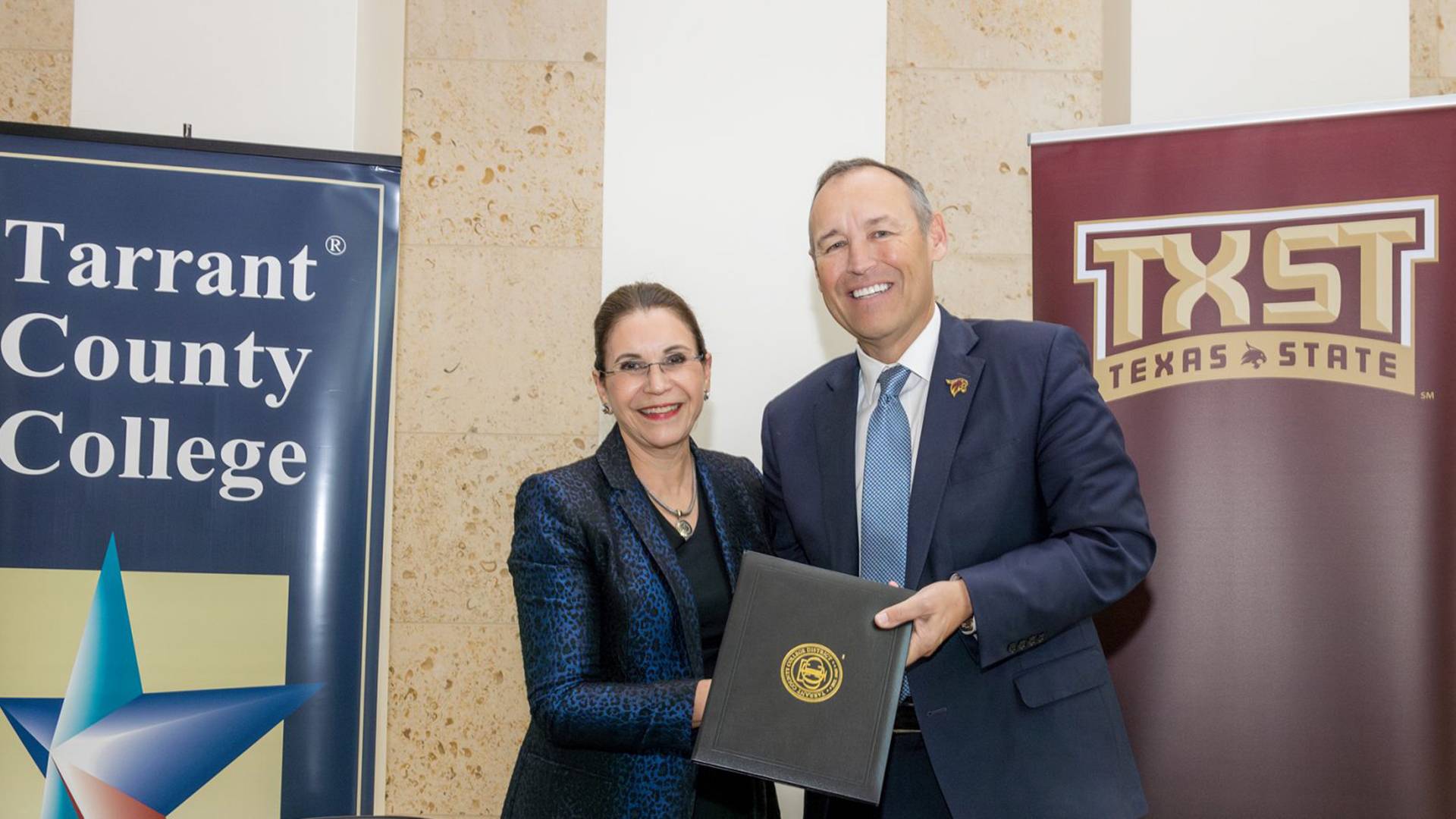 two people holding a certificate