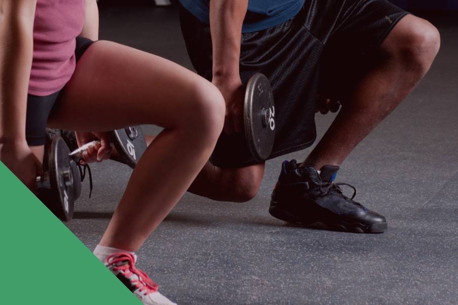 a man and woman lunging with dumbbells